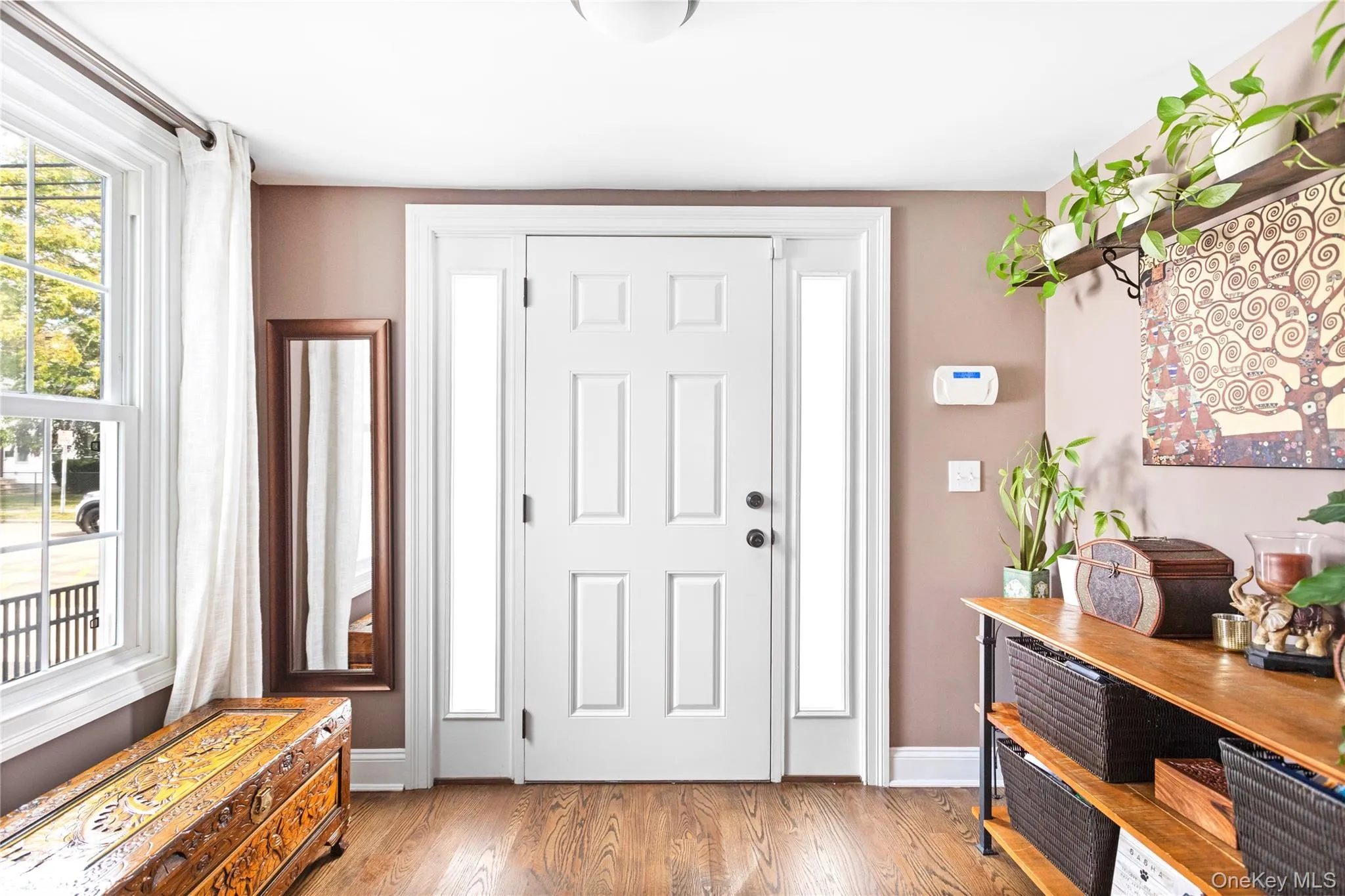 Foyer featuring wood finished floors and plenty of natural light Foyer featuring wood finished floors and plenty of natural light