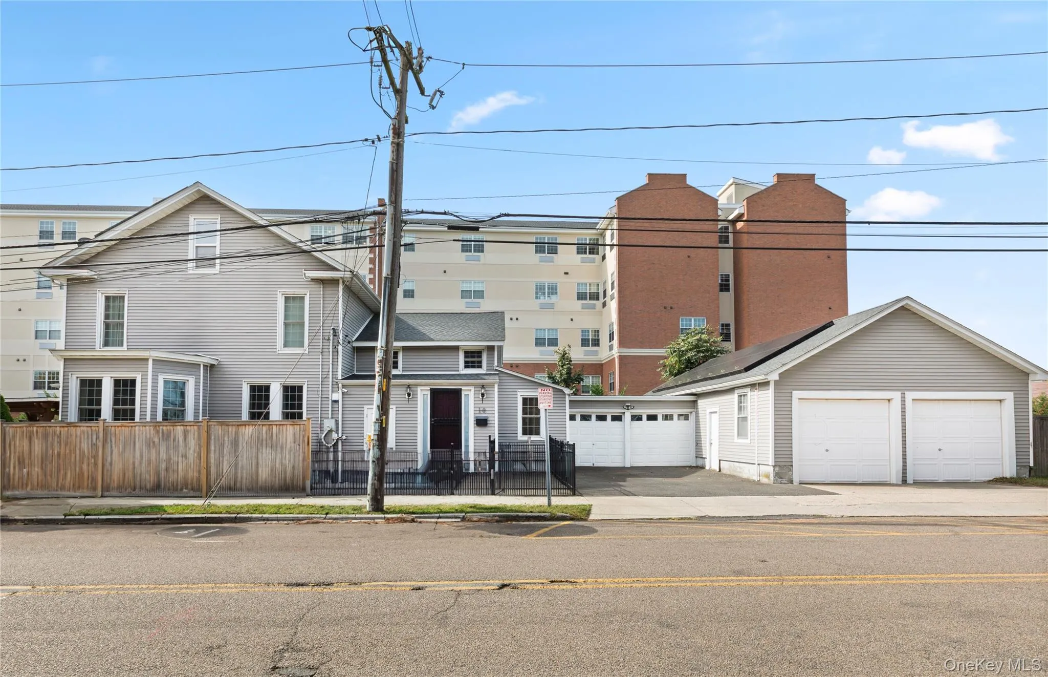 View of front facade featuring a fenced front yard and an outdoor structure View of front facade featuring a fenced front yard and an outdoor structure