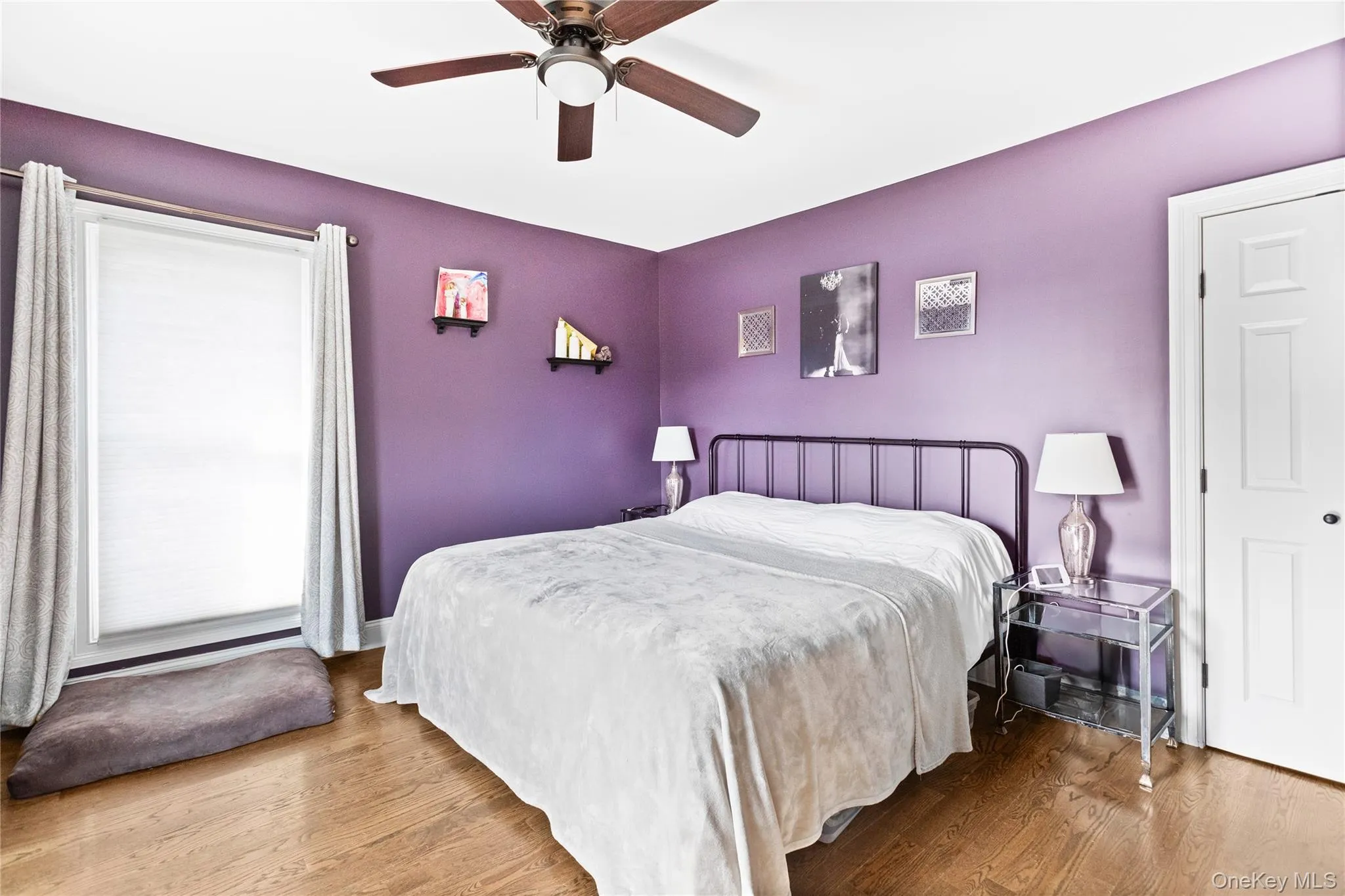 Bedroom with wood finished floors and a ceiling fan Bedroom with wood finished floors and a ceiling fan