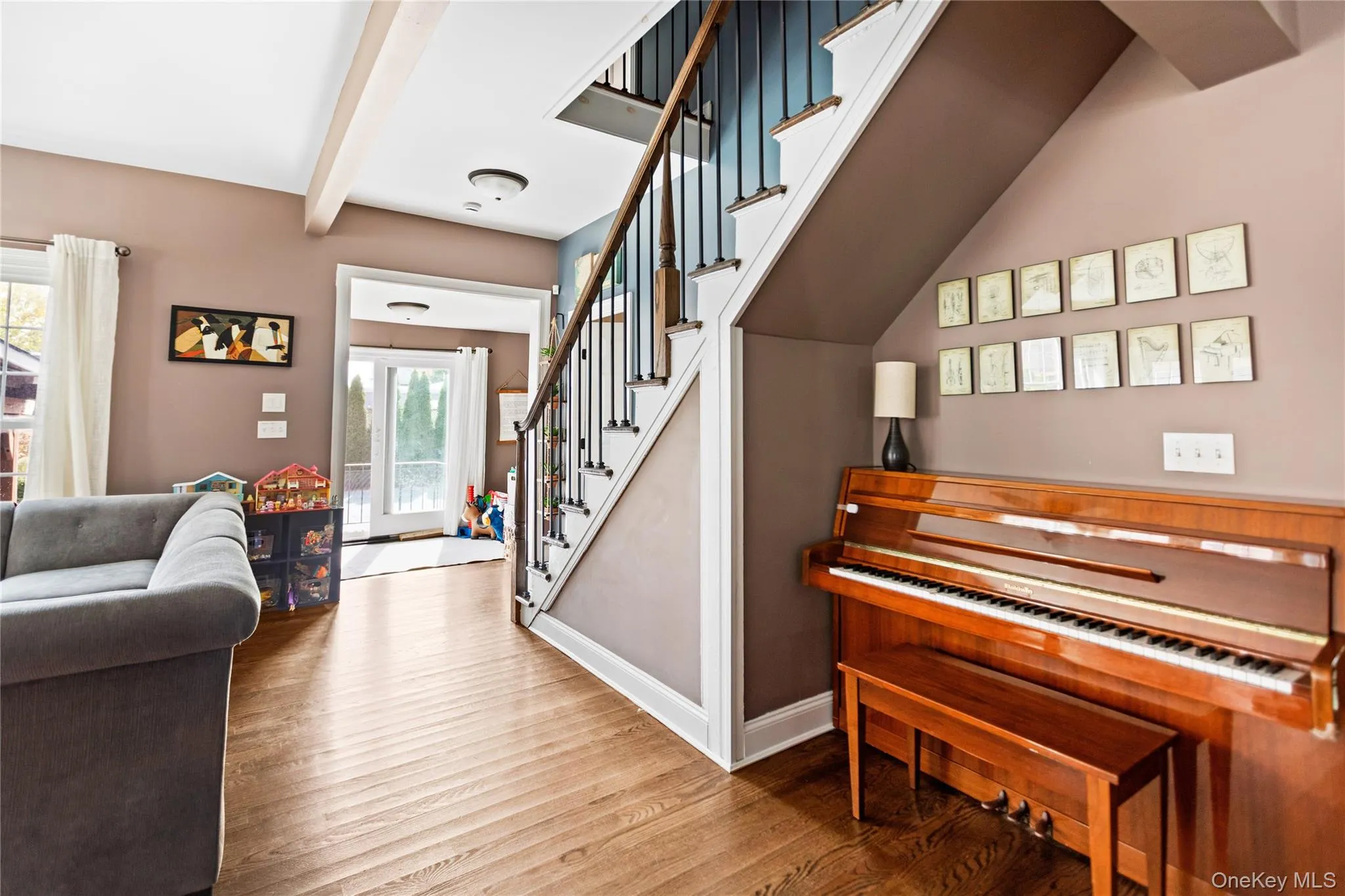 Stairway with beamed ceiling and wood finished floors Stairway with beamed ceiling and wood finished floors