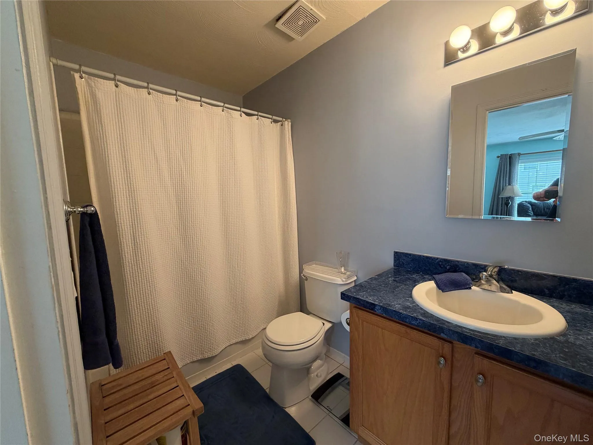 Bathroom featuring light tile patterned floors and vanity Bathroom featuring light tile patterned floors and vanity