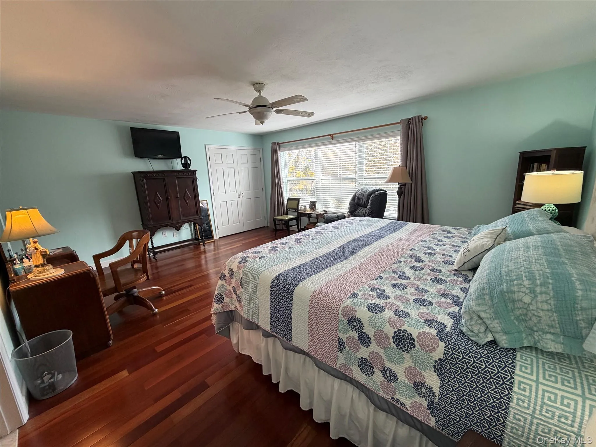 Bedroom with dark wood-type flooring, a closet, and ceiling fan Bedroom with dark wood-type flooring, a closet, and ceiling fan