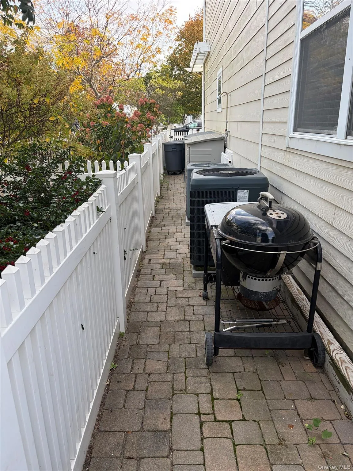 Fenced backyard with a patio area Fenced backyard with a patio area
