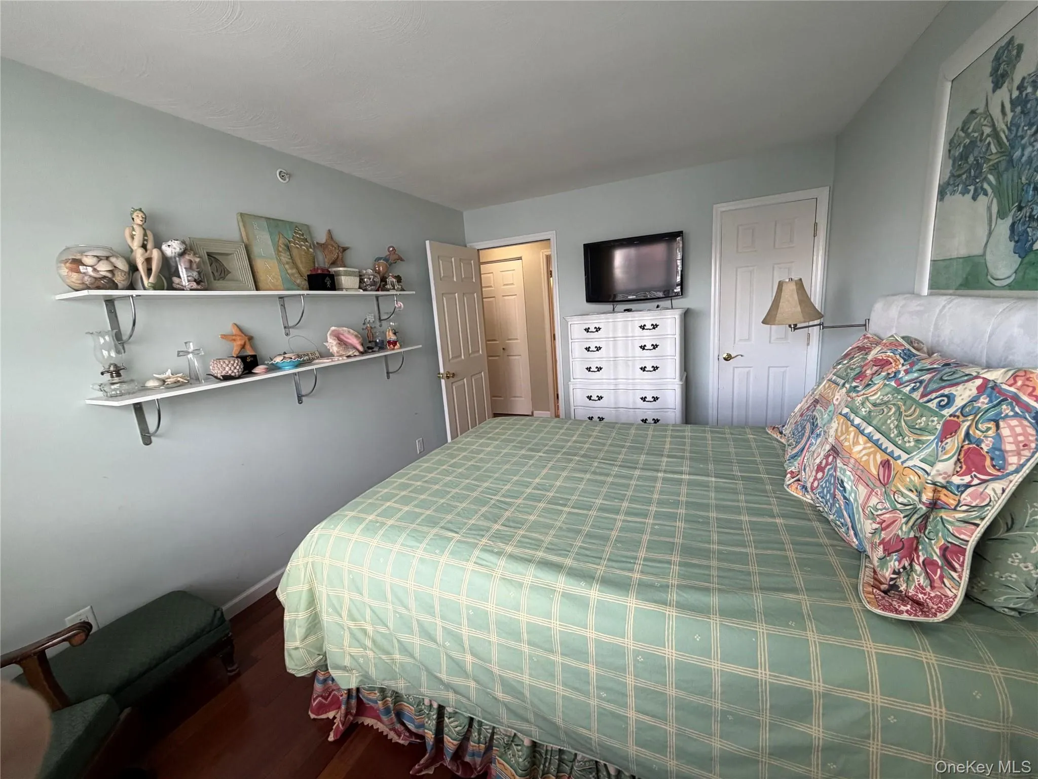 Bedroom featuring dark wood finished floors and baseboards Bedroom featuring dark wood finished floors and baseboards