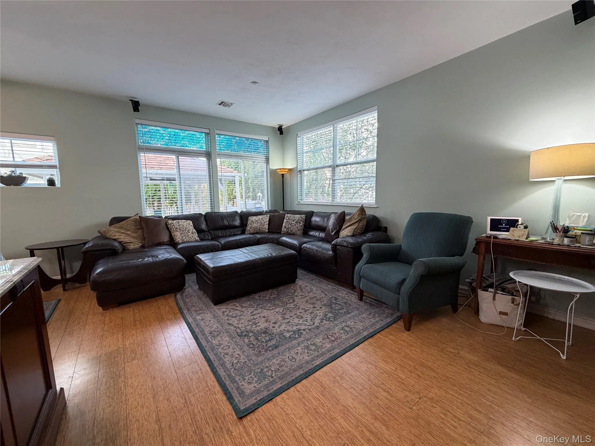 Living room with light wood-style floors and a desk Living room with light wood-style floors and a desk