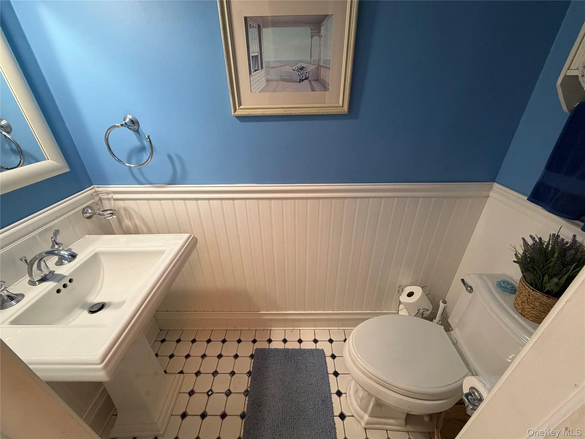 Half bathroom with wainscoting and toilet Half bathroom with wainscoting and toilet
