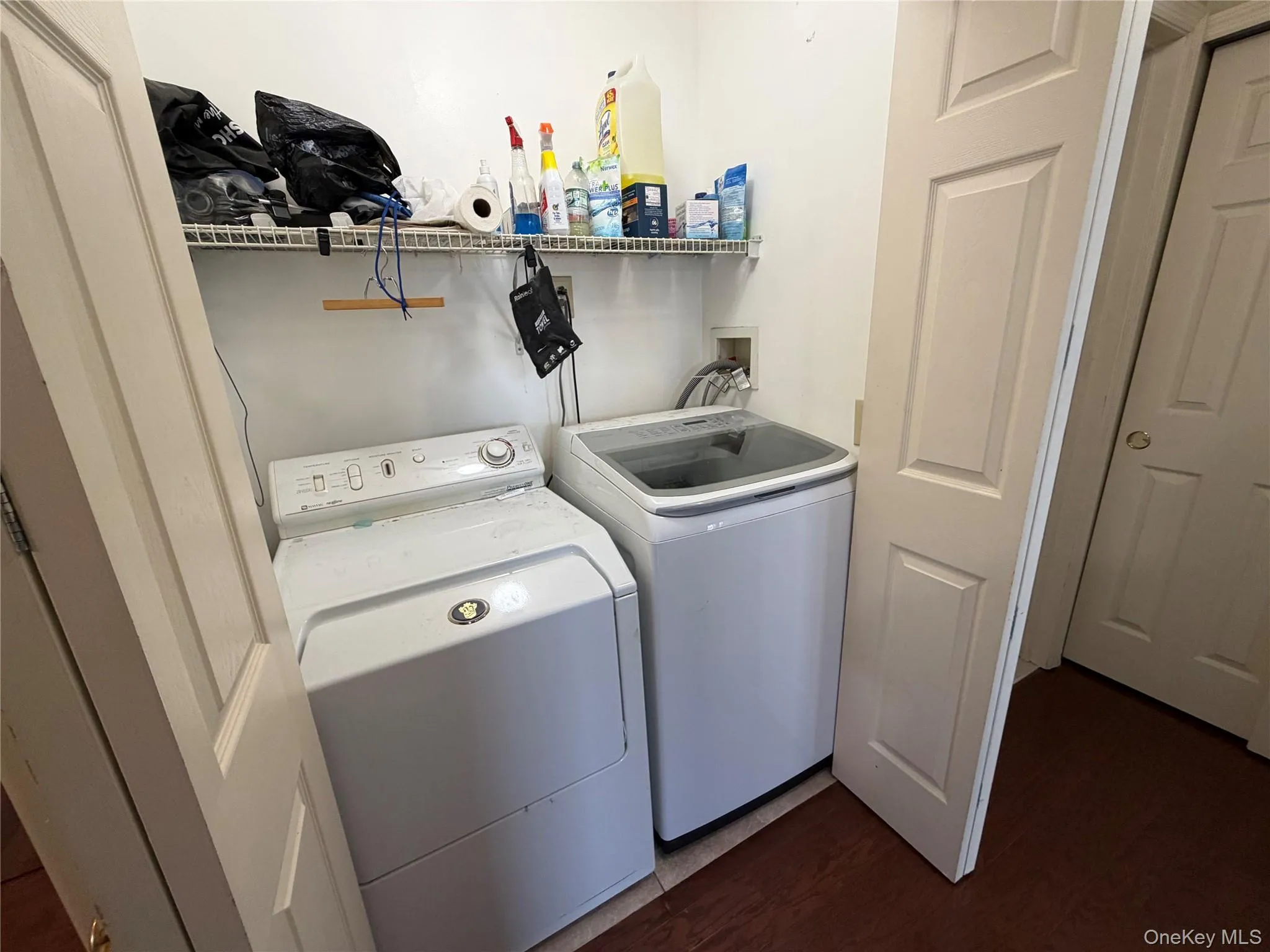 Laundry room with dark wood finished floors and separate washer and dryer Laundry room with dark wood finished floors and separate washer and dryer