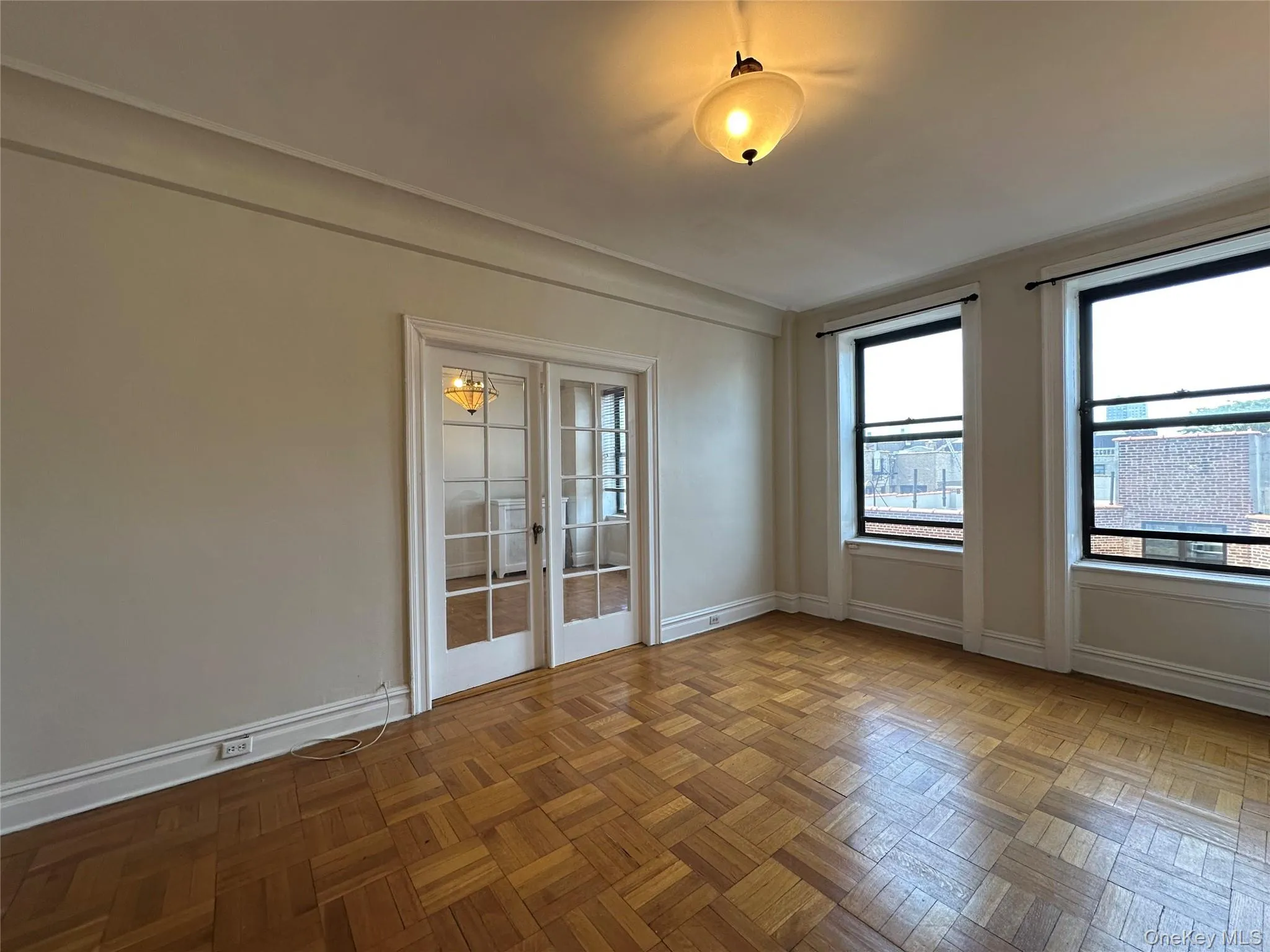 Empty room with french doors and baseboards Empty room with french doors and baseboards