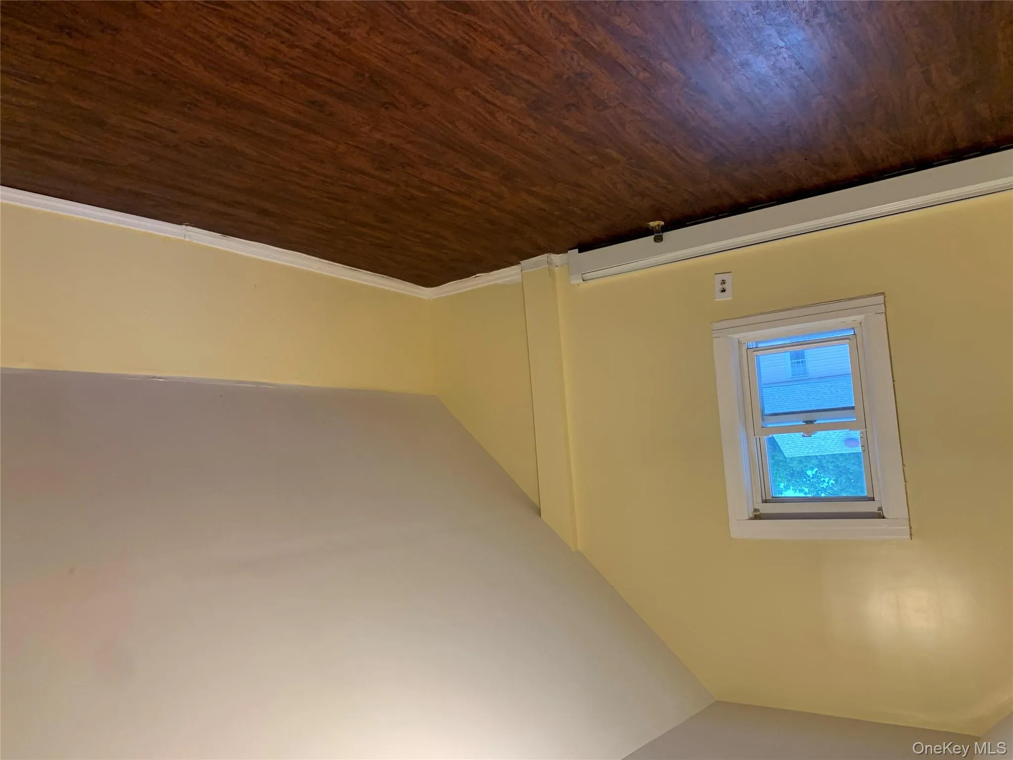 Bonus room featuring dark wood-style floors, a baseboard heating unit, and lofted ceiling Bonus room featuring dark wood-style floors, a baseboard heating unit, and lofted ceiling