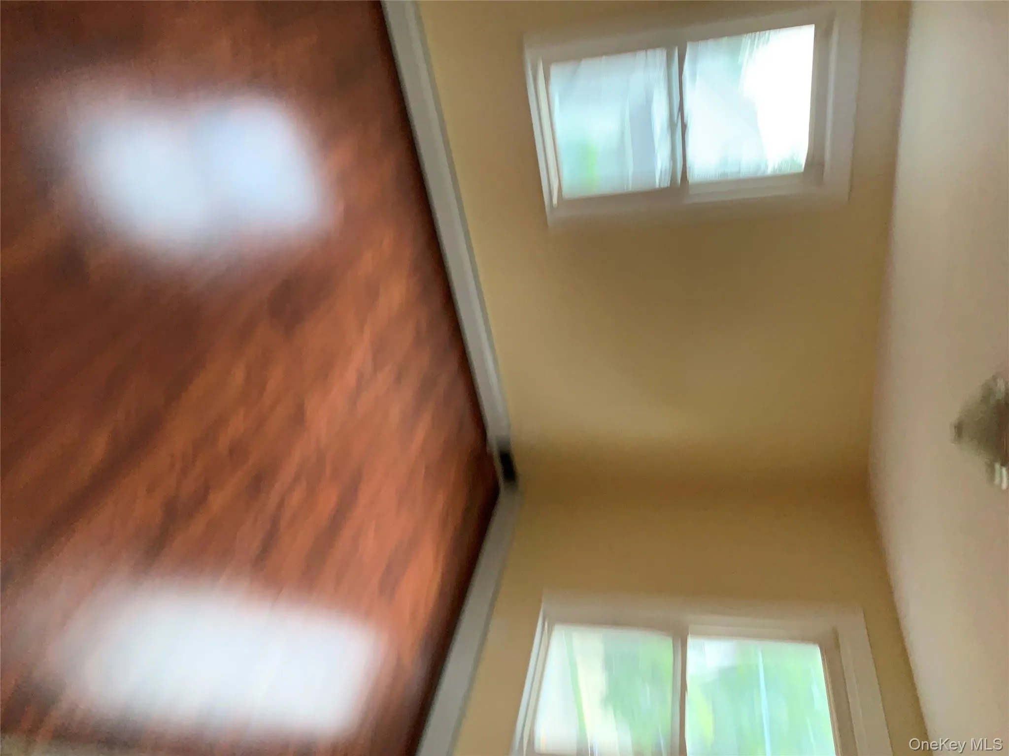 Empty room with wood finished floors and a baseboard radiator Empty room with wood finished floors and a baseboard radiator