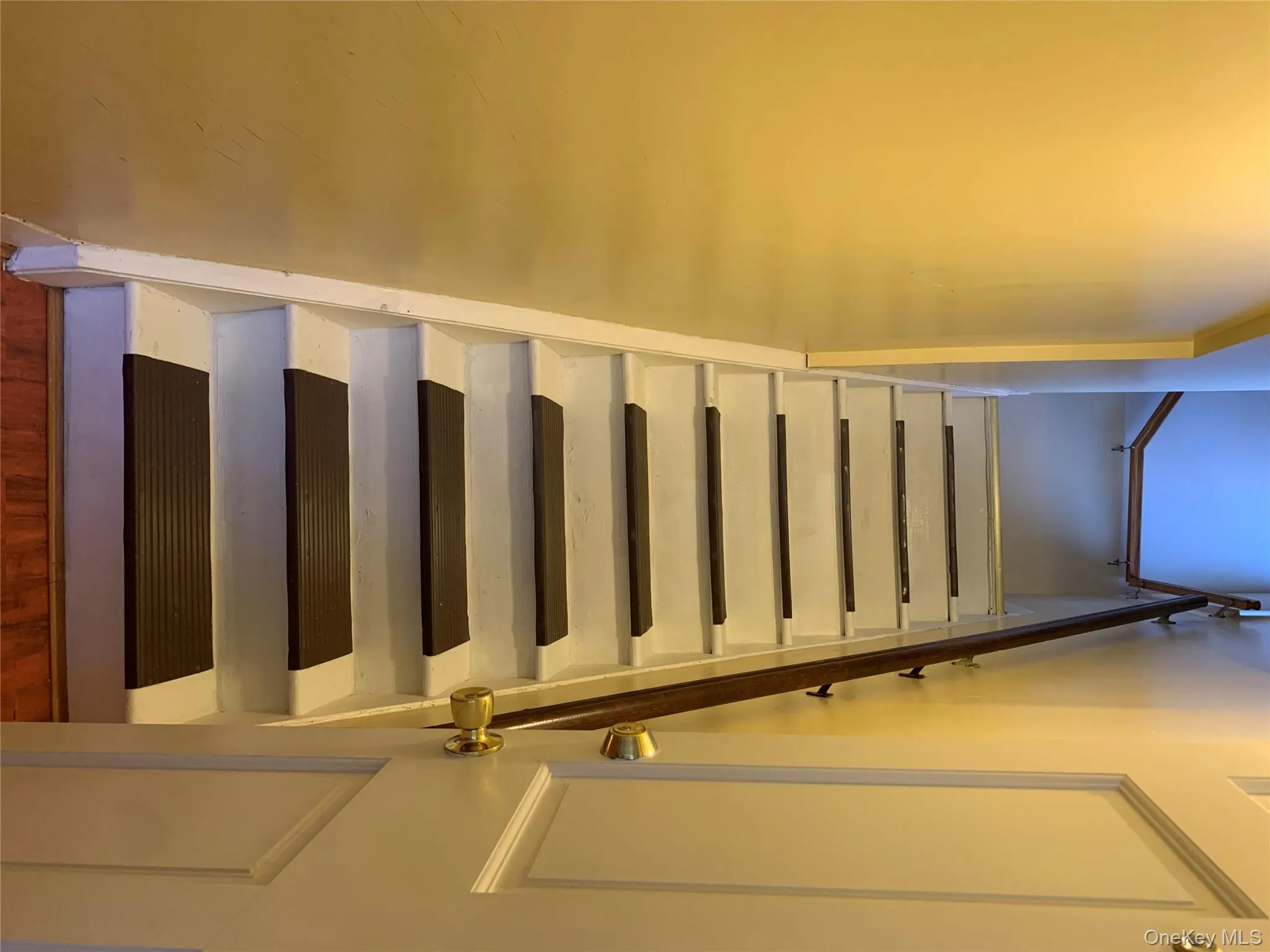 Stairs featuring wood finished floors Stairs featuring wood finished floors