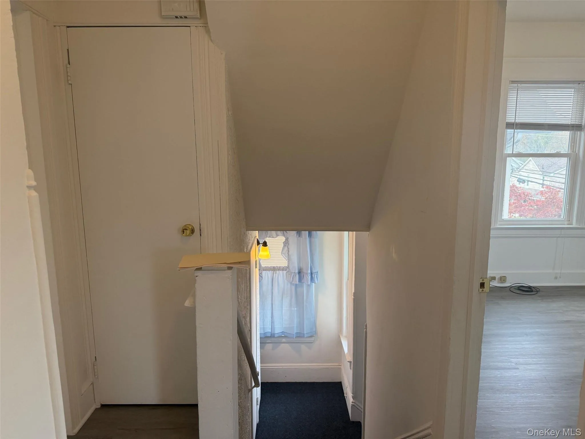 Hall with healthy amount of natural light and dark wood-style flooring Hall with healthy amount of natural light and dark wood-style flooring