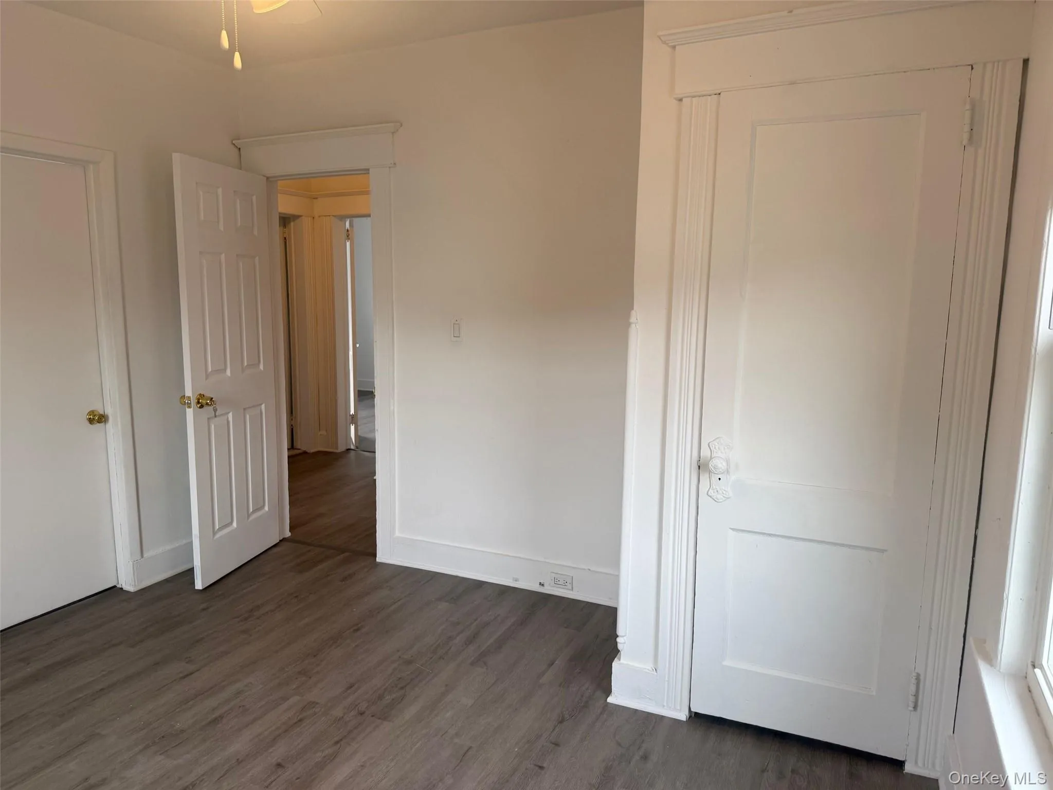 Another angle of bedroom with dark wood-type flooring Another angle of bedroom with dark wood-type flooring