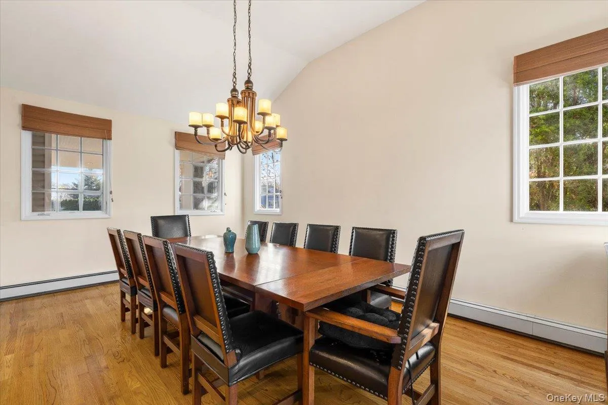 Formal dining room sunken down from the kitchen with a vaulted ceiling and door to outdoor bluestone patio Formal dining room sunken down from the kitchen with a vaulted ceiling and door to outdoor bluestone patio