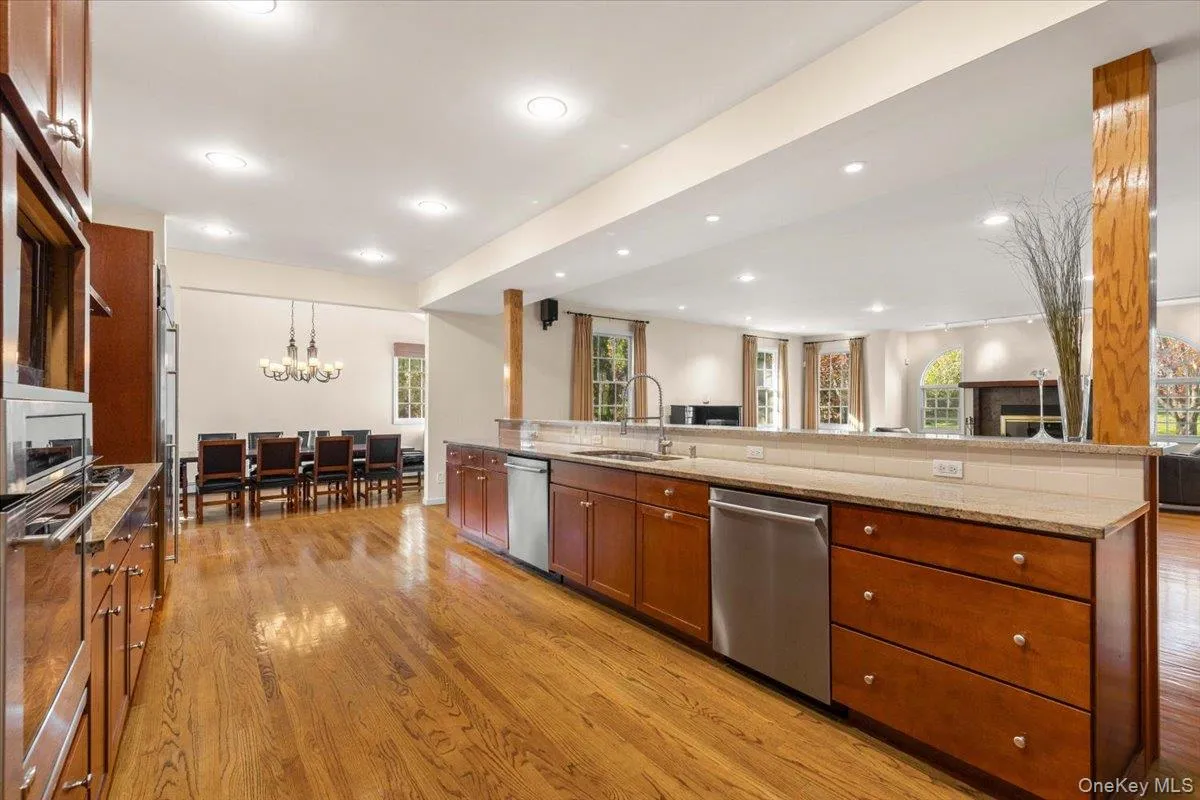 Oversized kitchen with dual dishwashers, stainless steel appliances, island seating, and open concept into the dining room & family room Oversized kitchen with dual dishwashers, stainless steel appliances, island seating, and open concept into the dining room & family room