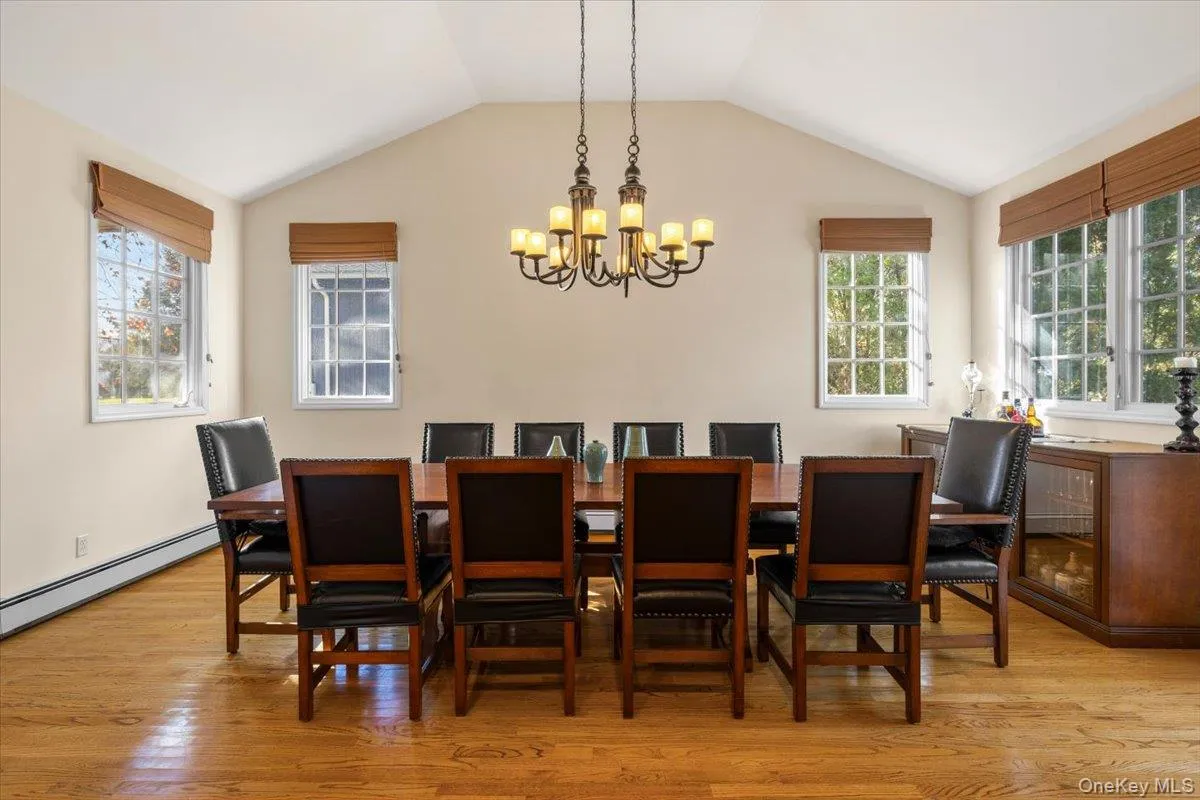 Formal dining room sunken down from the kitchen with a vaulted ceiling and door to outdoor bluestone patio Formal dining room sunken down from the kitchen with a vaulted ceiling and door to outdoor bluestone patio