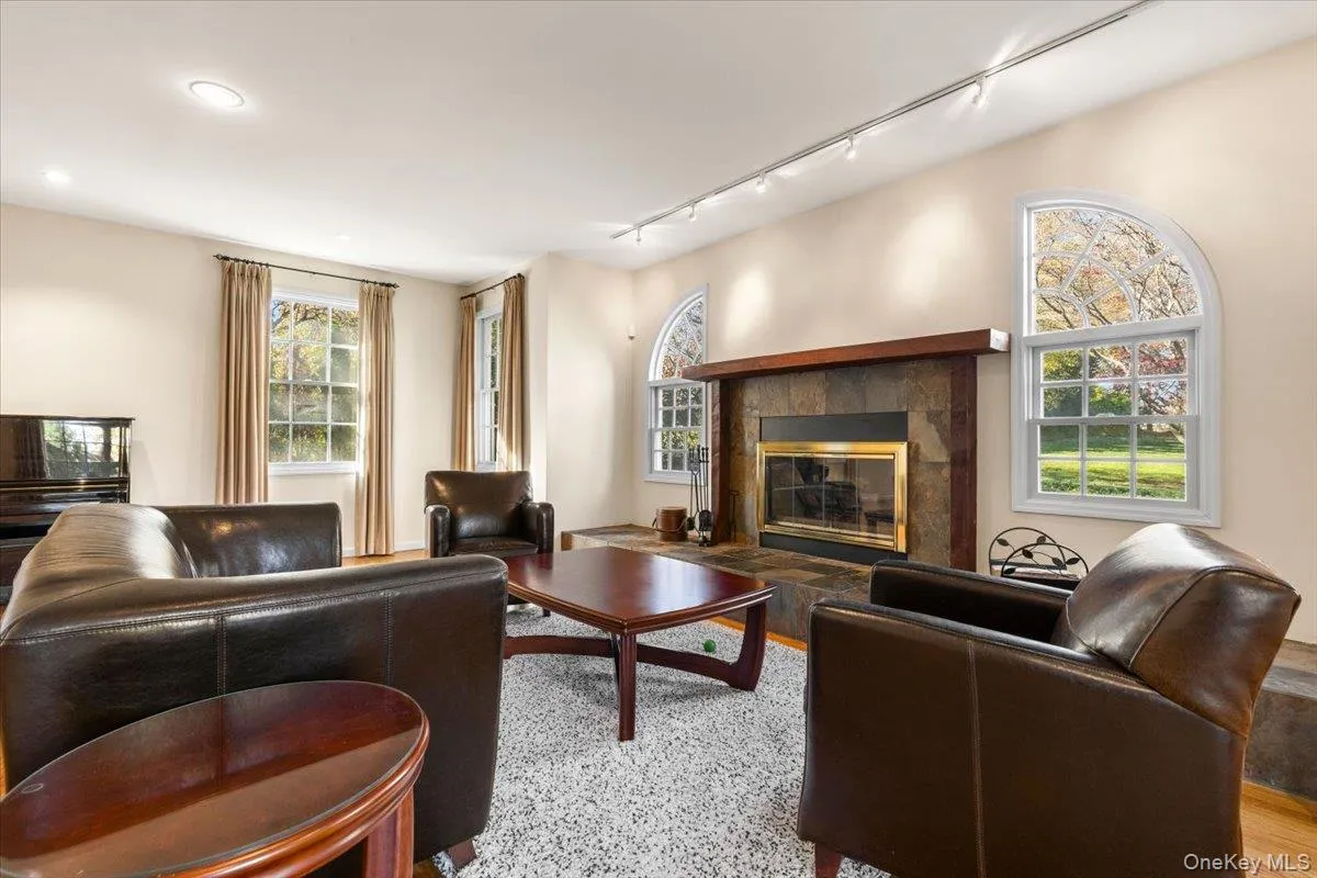 Family room with wood burning fireplace, large windows Family room with wood burning fireplace, large windows