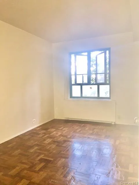 Spare room with radiator heating unit and baseboards Spare room with radiator heating unit and baseboards