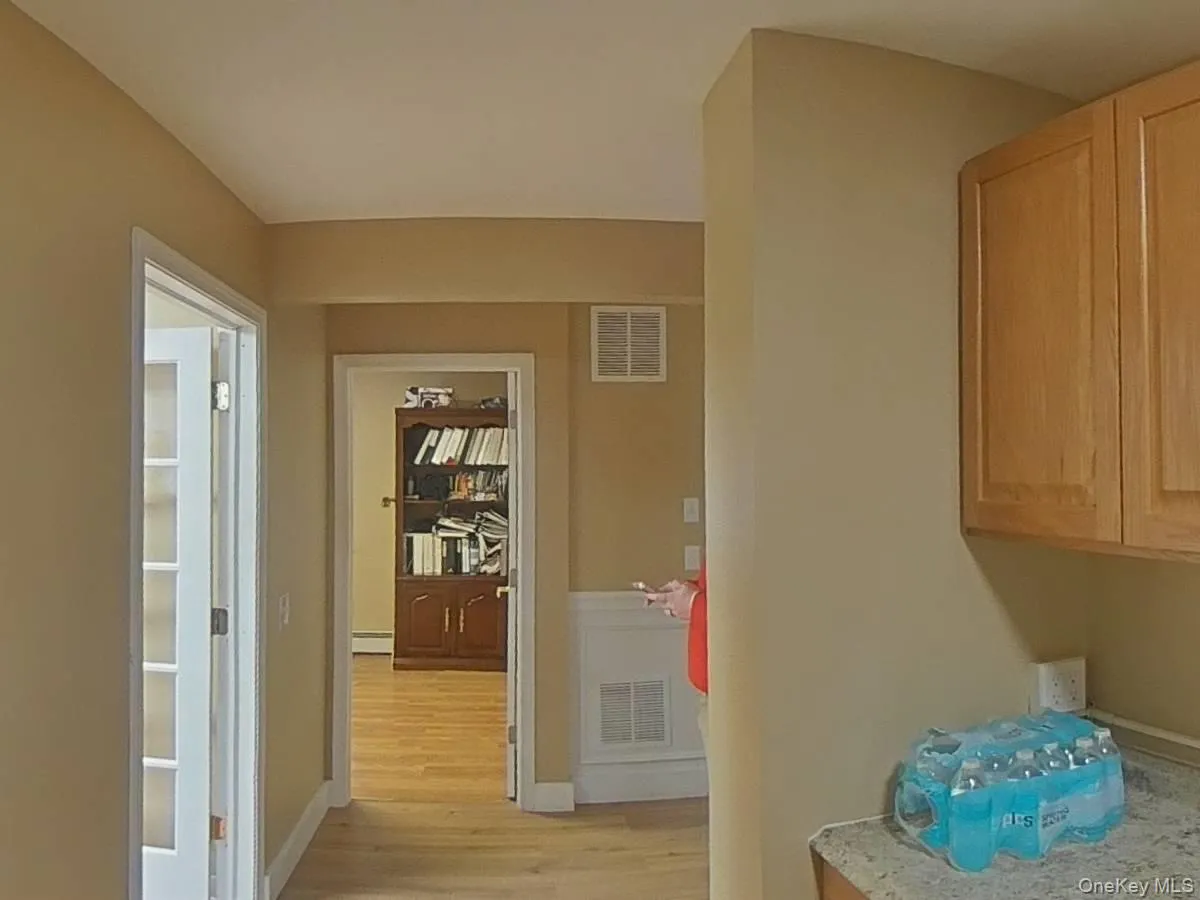 Hall featuring light wood finished floors and baseboards Hall featuring light wood finished floors and baseboards