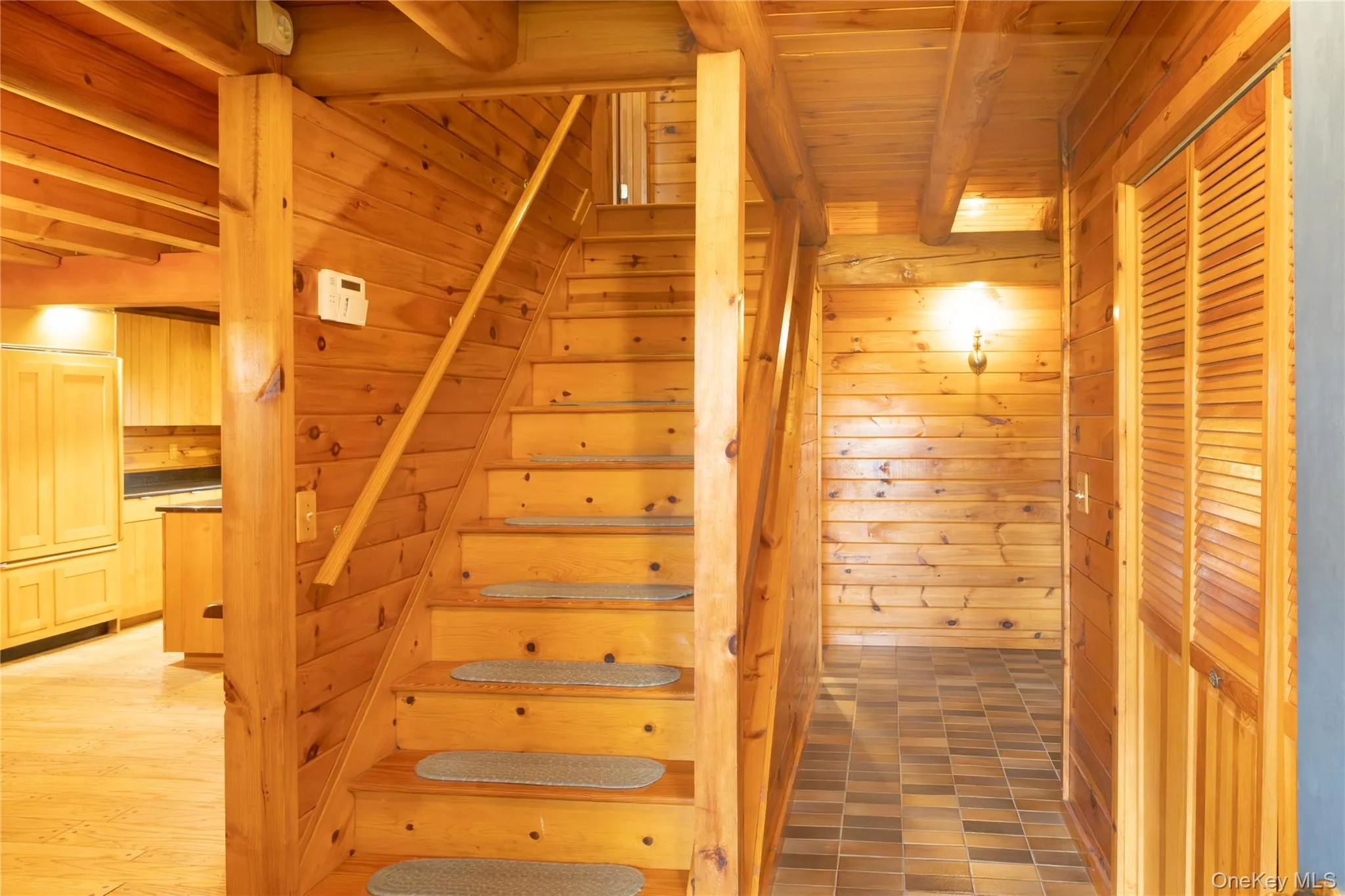 Staircase with wooden walls and a wooden ceiling with exposed beams Staircase with wooden walls and a wooden ceiling with exposed beams