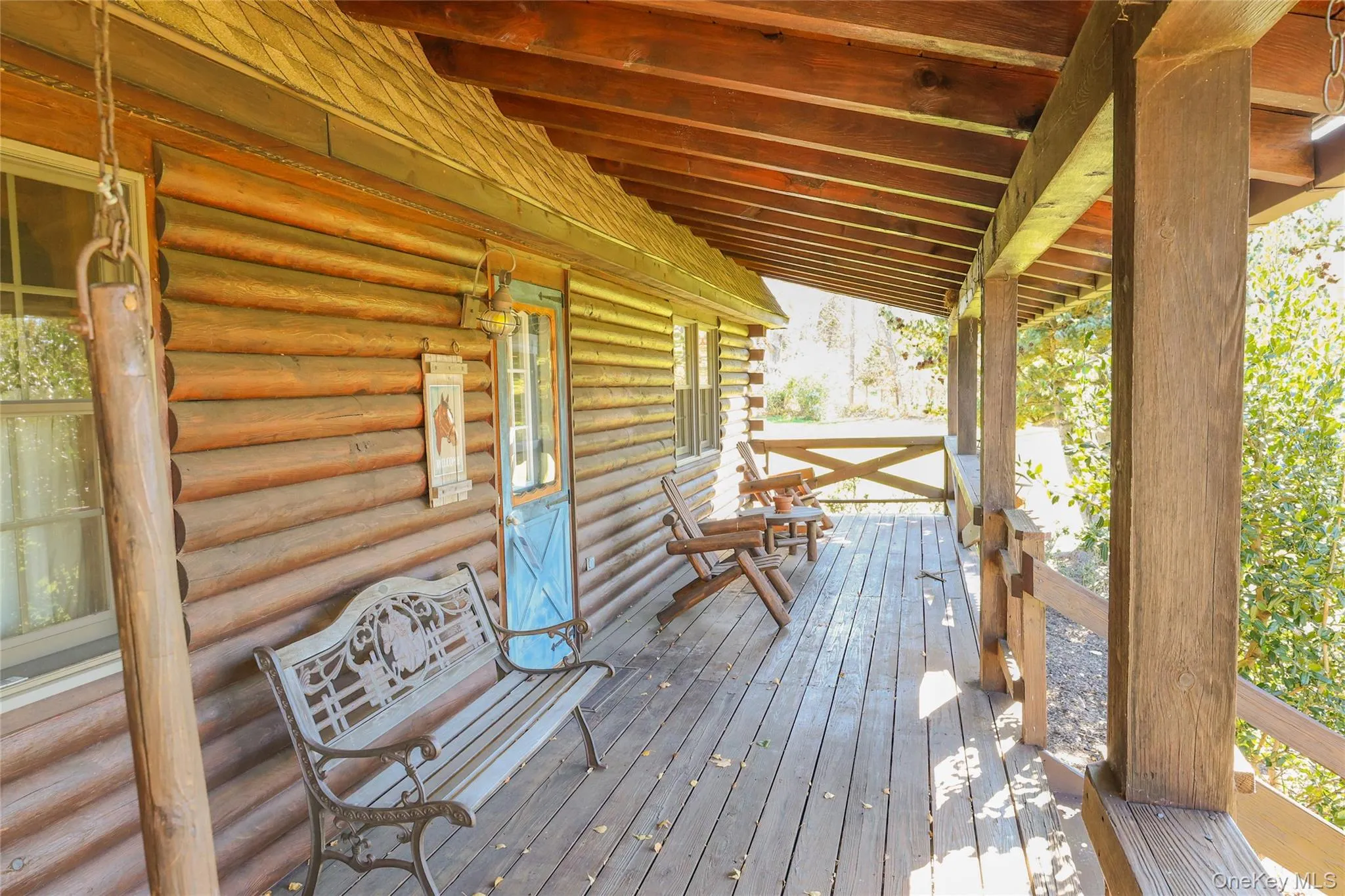 Step onto the inviting front porch of this classic log cabin, where rustic charm meets everyday comfort. Step onto the inviting front porch of this classic log cabin, where rustic charm meets everyday comfort.