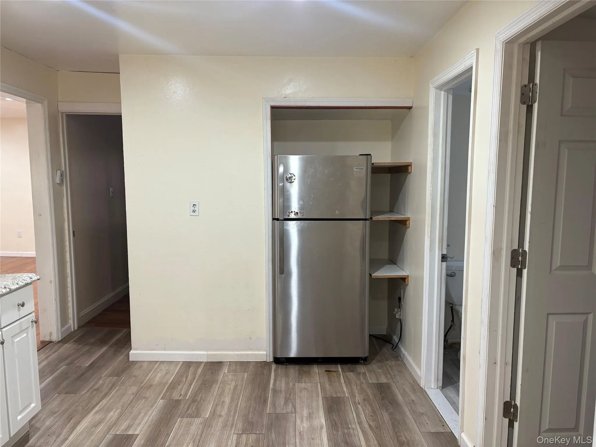 Kitchen with freestanding refrigerator and dark wood-type flooring Kitchen with freestanding refrigerator and dark wood-type flooring