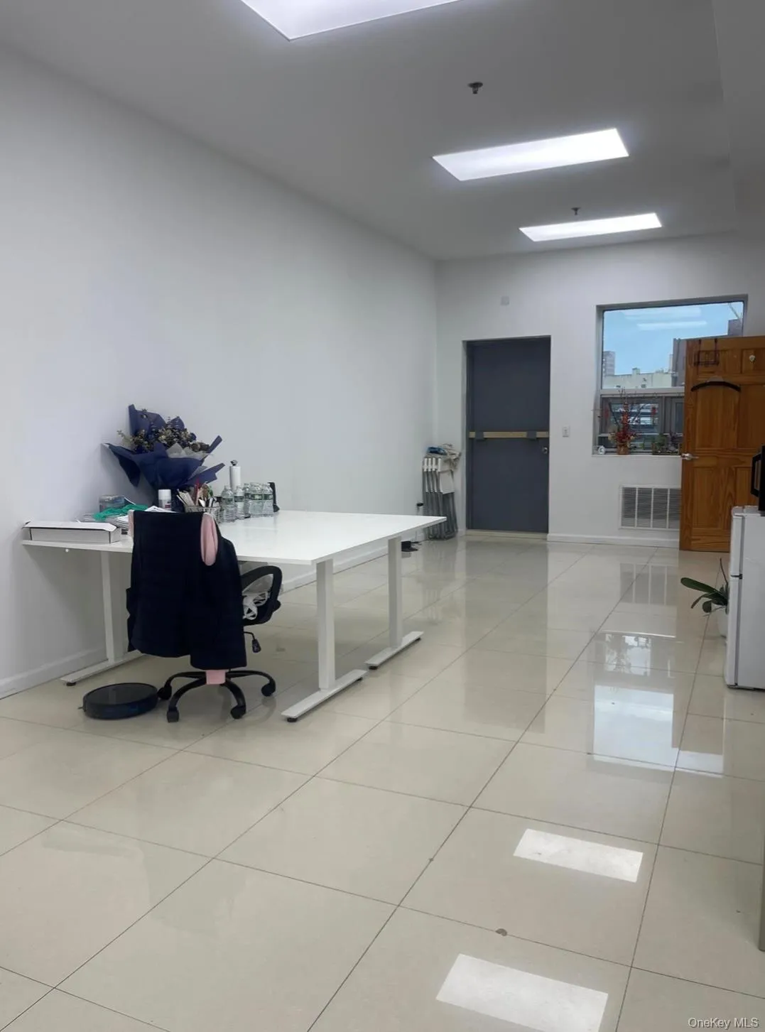 Office area with light tile patterned flooring and baseboards Office area with light tile patterned flooring and baseboards