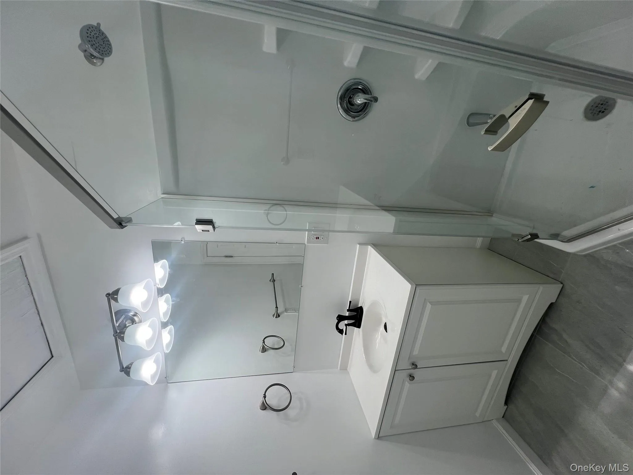 Full bath featuring a shower stall and vanity Full bath featuring a shower stall and vanity