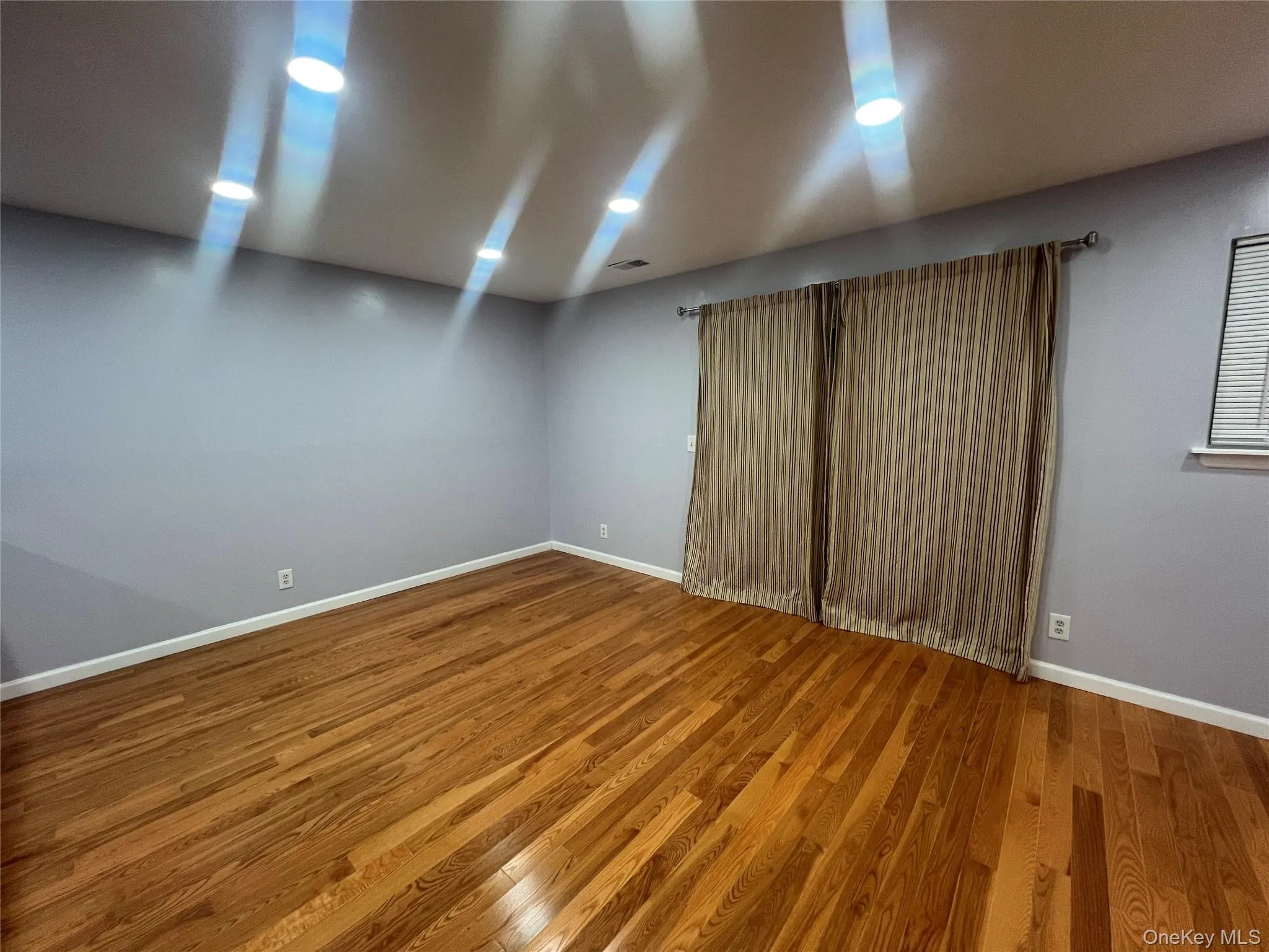 Unfurnished room featuring wood finished floors Unfurnished room featuring wood finished floors