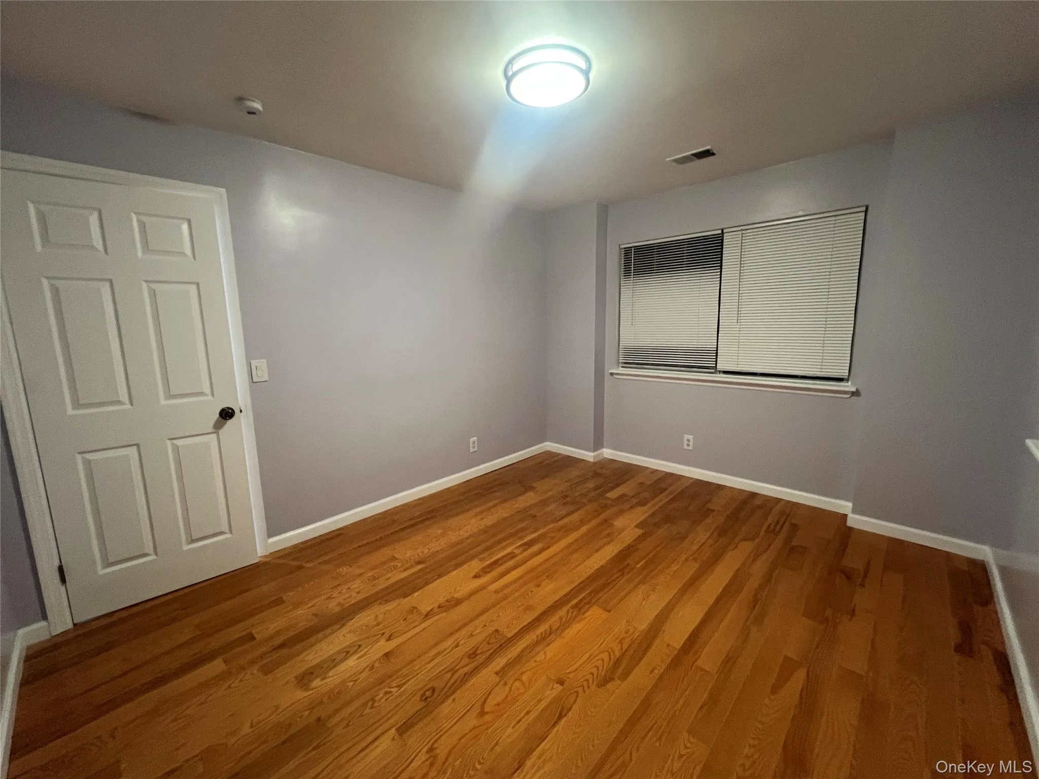 Unfurnished room featuring wood finished floors and baseboards Unfurnished room featuring wood finished floors and baseboards