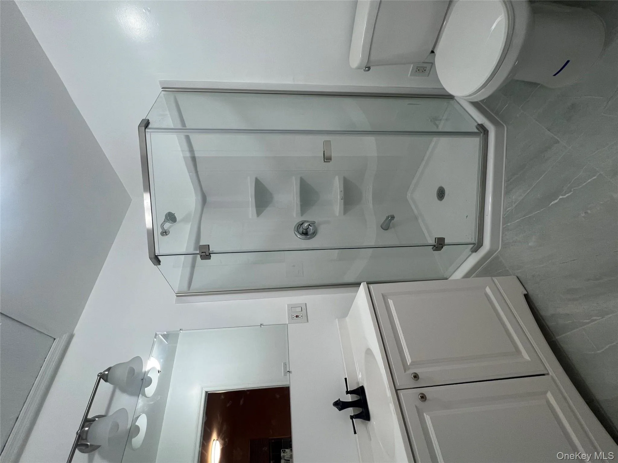 Full bathroom with vanity, a stall shower, and marble finish floors Full bathroom with vanity, a stall shower, and marble finish floors