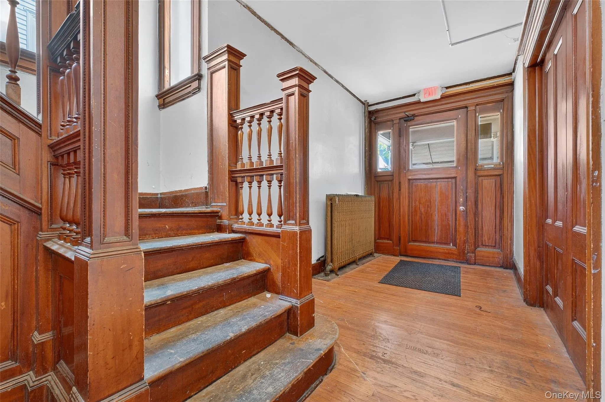 Entryway with light wood-style flooring and stairway Entryway with light wood-style flooring and stairway
