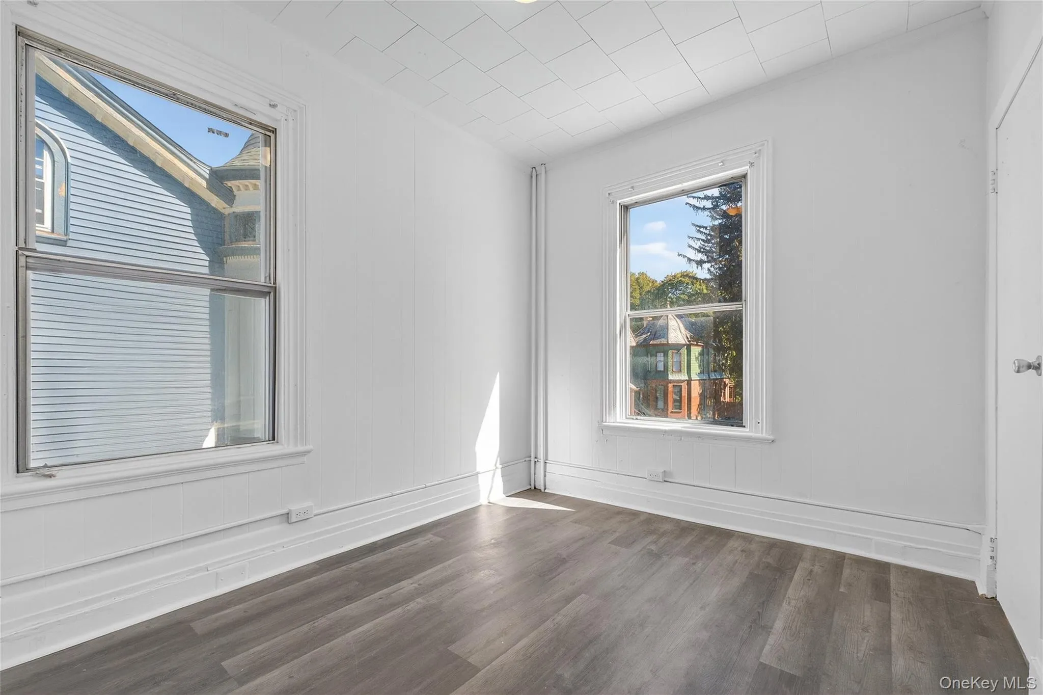 Empty room featuring dark wood-style flooring Empty room featuring dark wood-style flooring