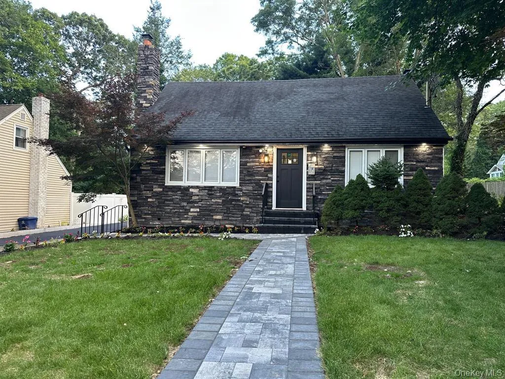 View of front of property featuring stone siding, a shingled roof, and a chimney View of front of property featuring stone siding, a shingled roof, and a chimney