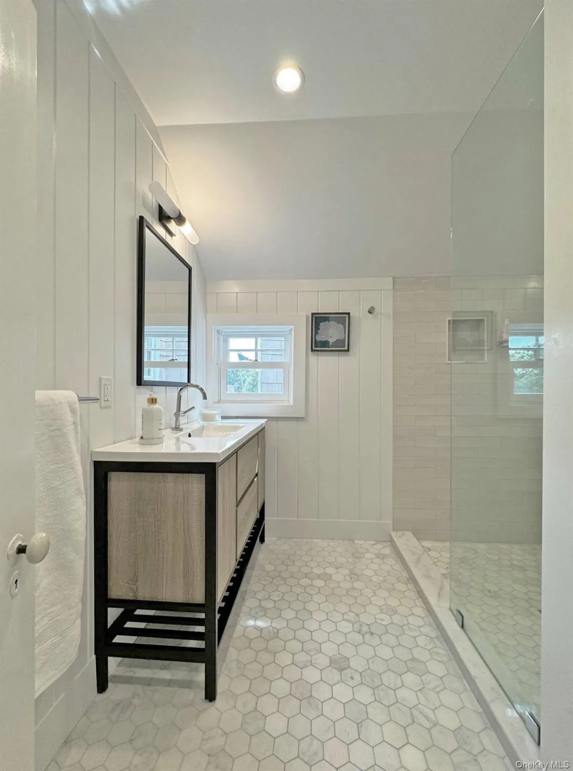 Full bathroom featuring vanity, walk in shower, and light tile patterned floors Full bathroom featuring vanity, walk in shower, and light tile patterned floors