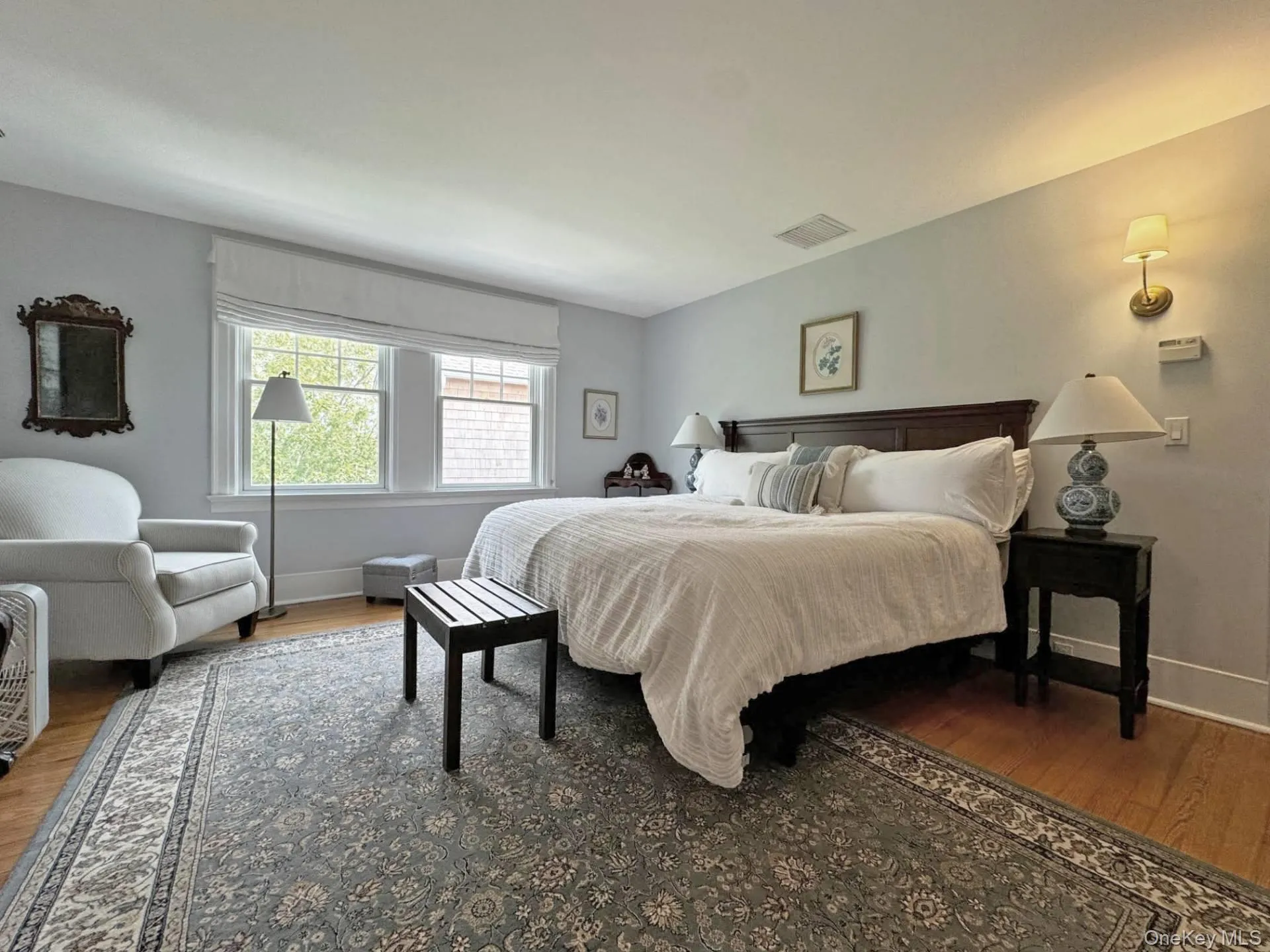 Bedroom featuring wood finished floors and baseboards Bedroom featuring wood finished floors and baseboards