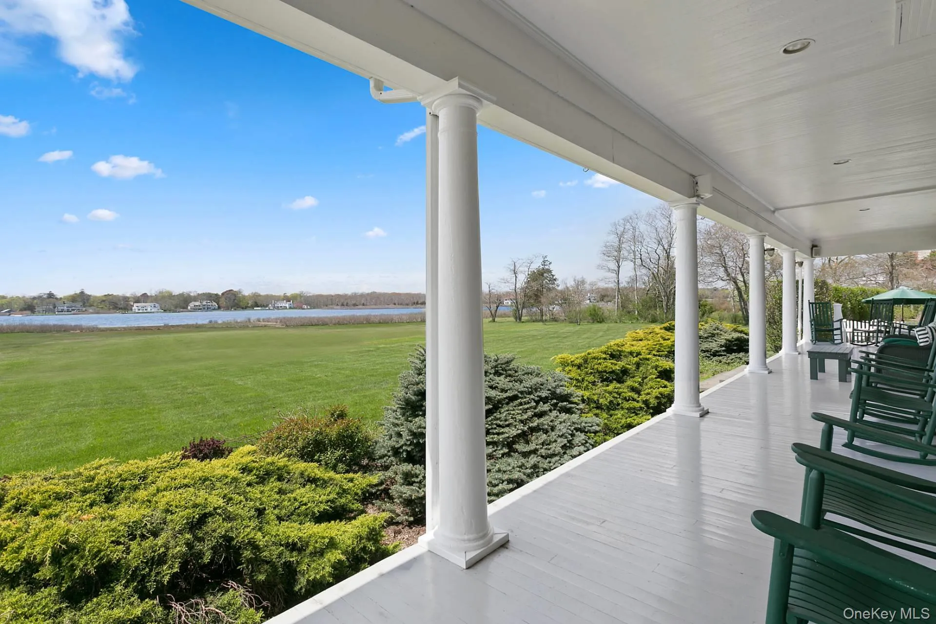 Wooden deck featuring a water view and a yard Wooden deck featuring a water view and a yard