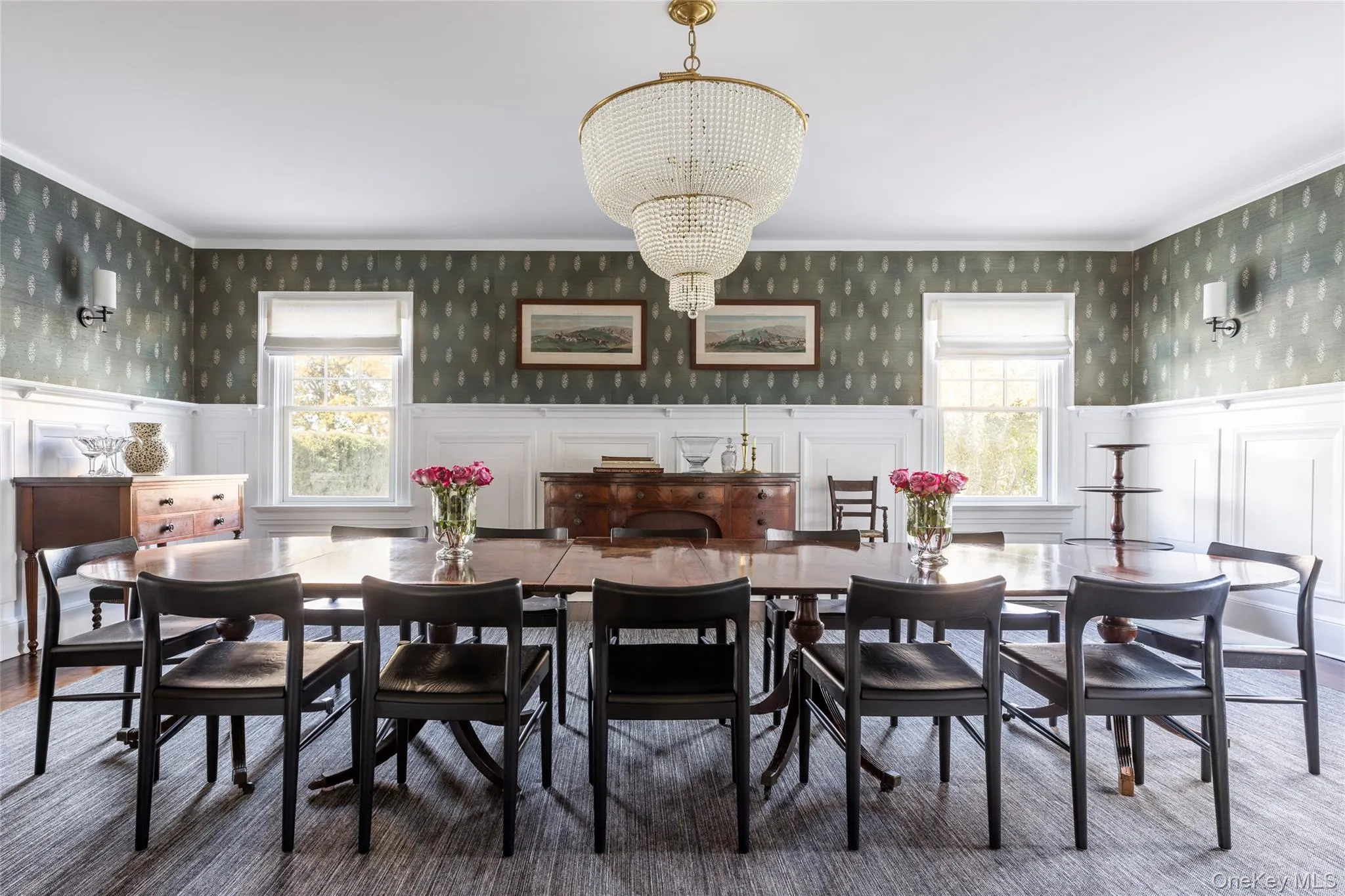 Dining area featuring wallpapered walls, a decorative wall, wainscoting, a chandelier, and healthy amount of natural light Dining area featuring wallpapered walls, a decorative wall, wainscoting, a chandelier, and healthy amount of natural light