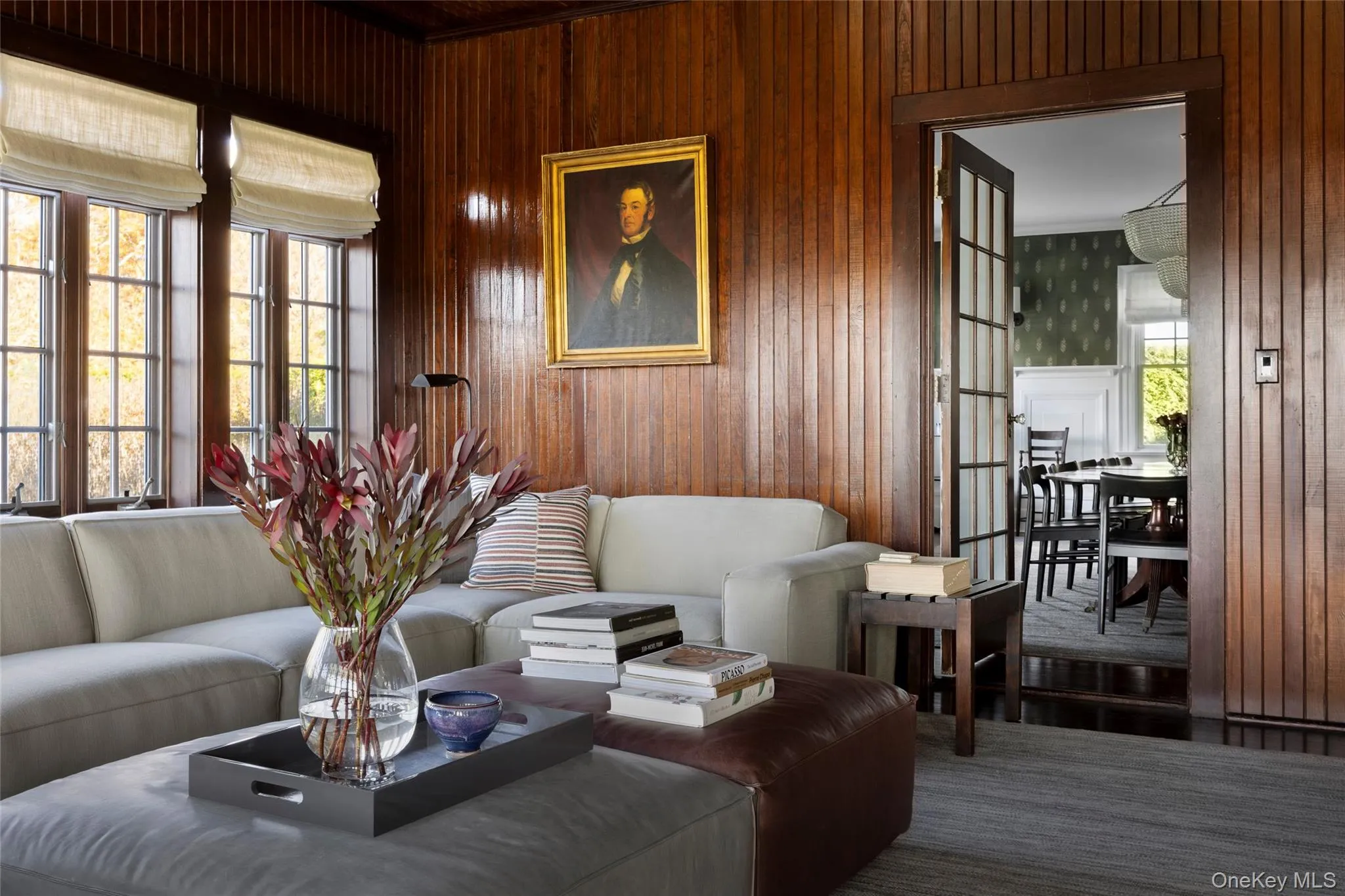 Living area with plenty of natural light and wood walls Living area with plenty of natural light and wood walls