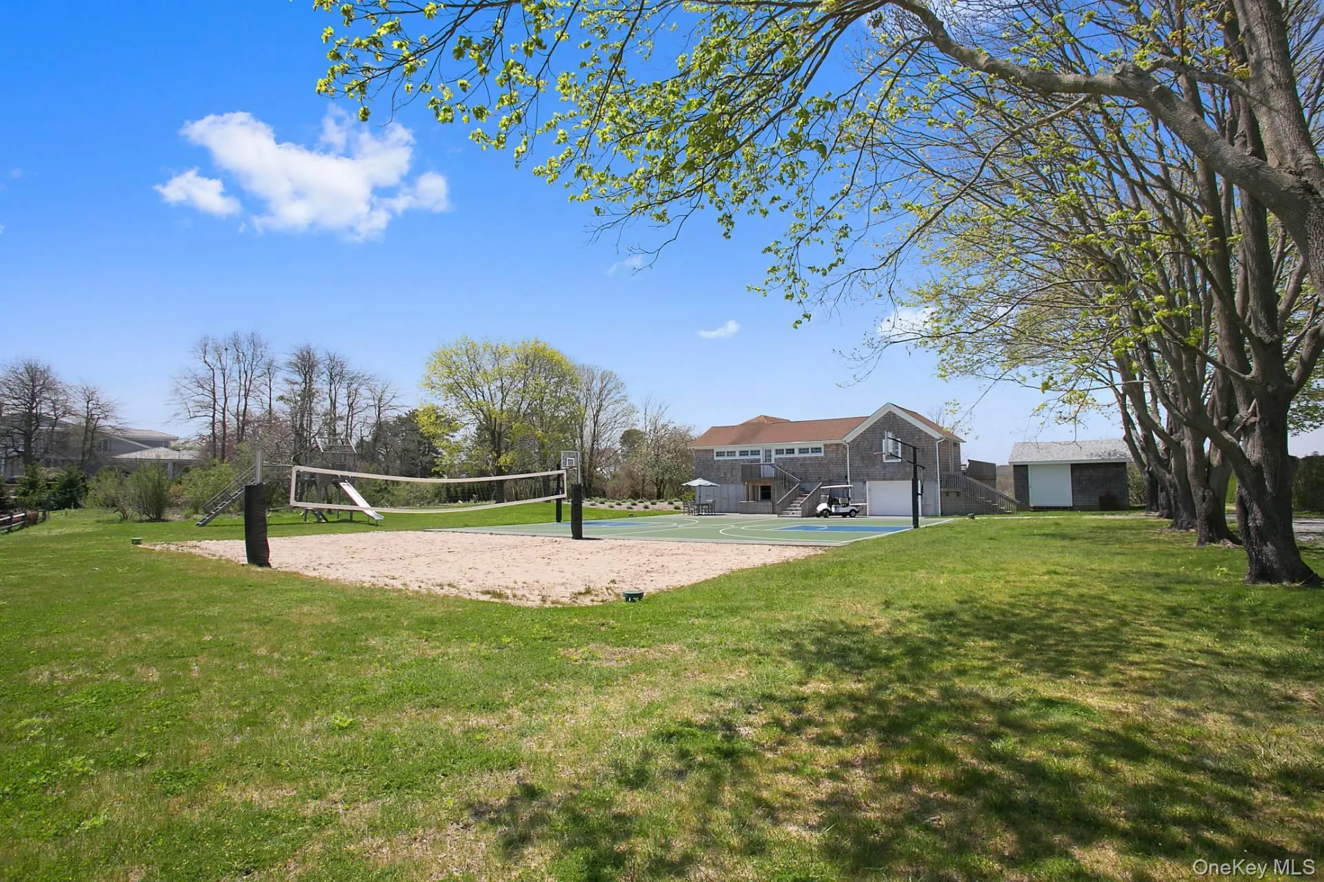 View of community featuring a yard, stairs, and volleyball court View of community featuring a yard, stairs, and volleyball court