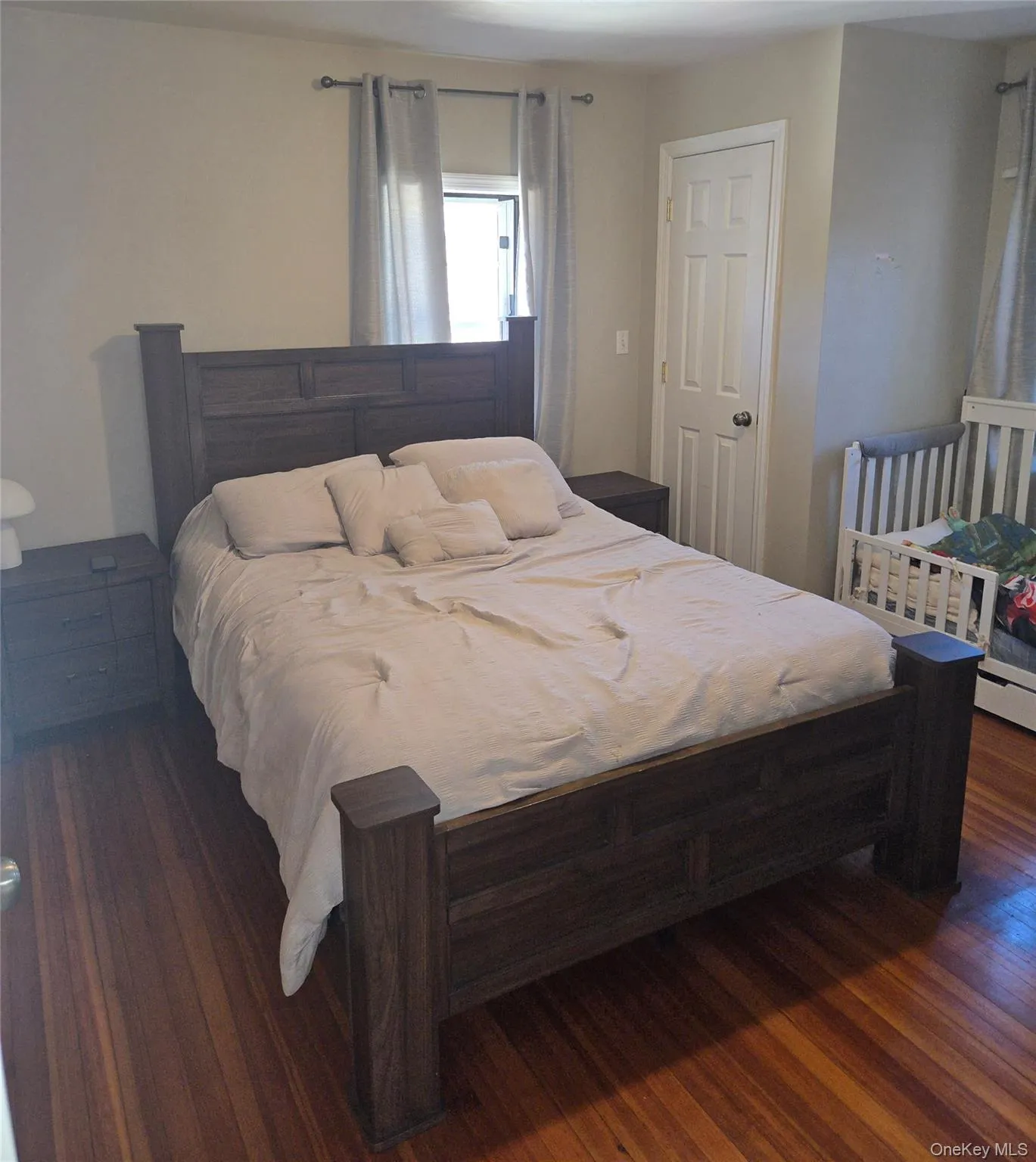 Bedroom featuring oak floors Bedroom featuring oak floors