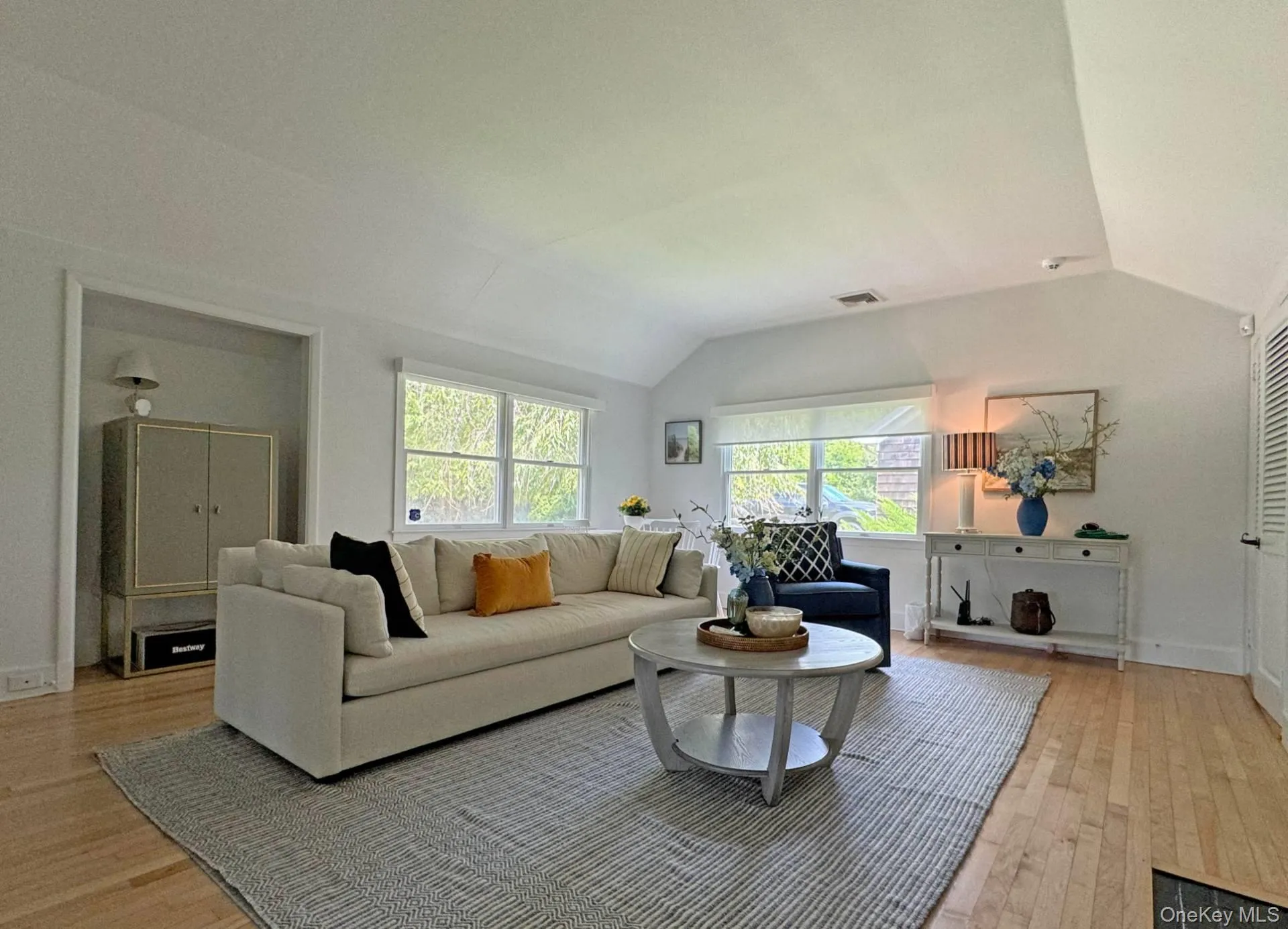 Living room featuring lofted ceiling and light wood finished floors Living room featuring lofted ceiling and light wood finished floors