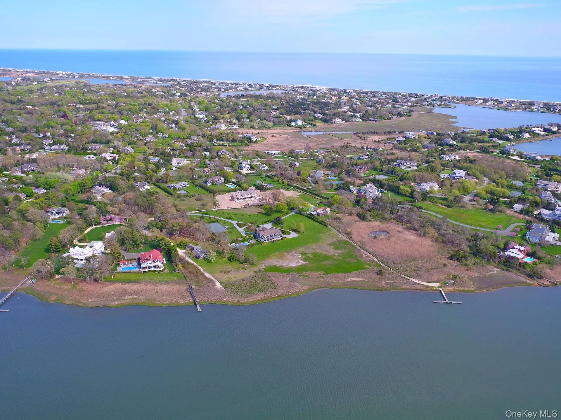 Aerial view of property and surrounding area with a nearby body of water Aerial view of property and surrounding area with a nearby body of water