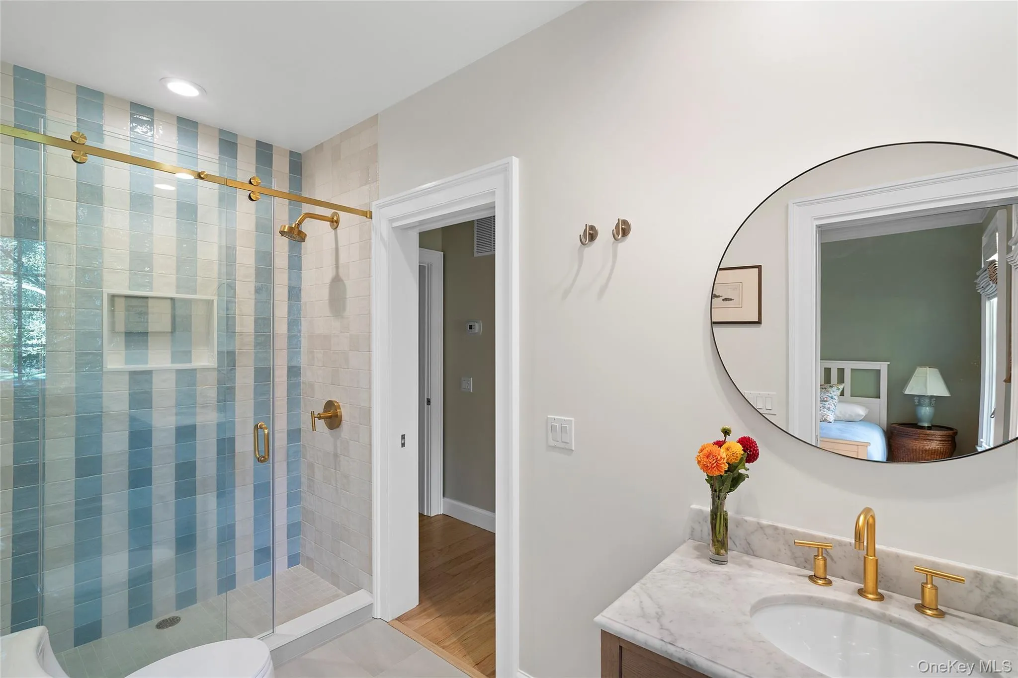 Bathroom with vanity, a shower stall, and light tile patterned floors Bathroom with vanity, a shower stall, and light tile patterned floors