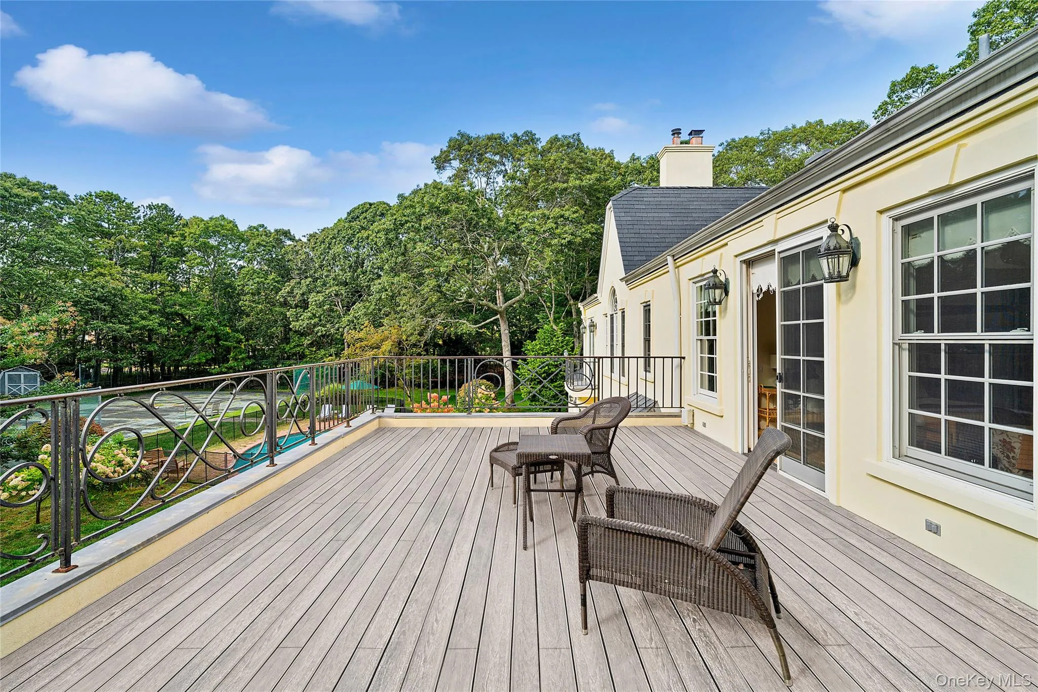 Wooden deck featuring view of scattered trees Wooden deck featuring view of scattered trees