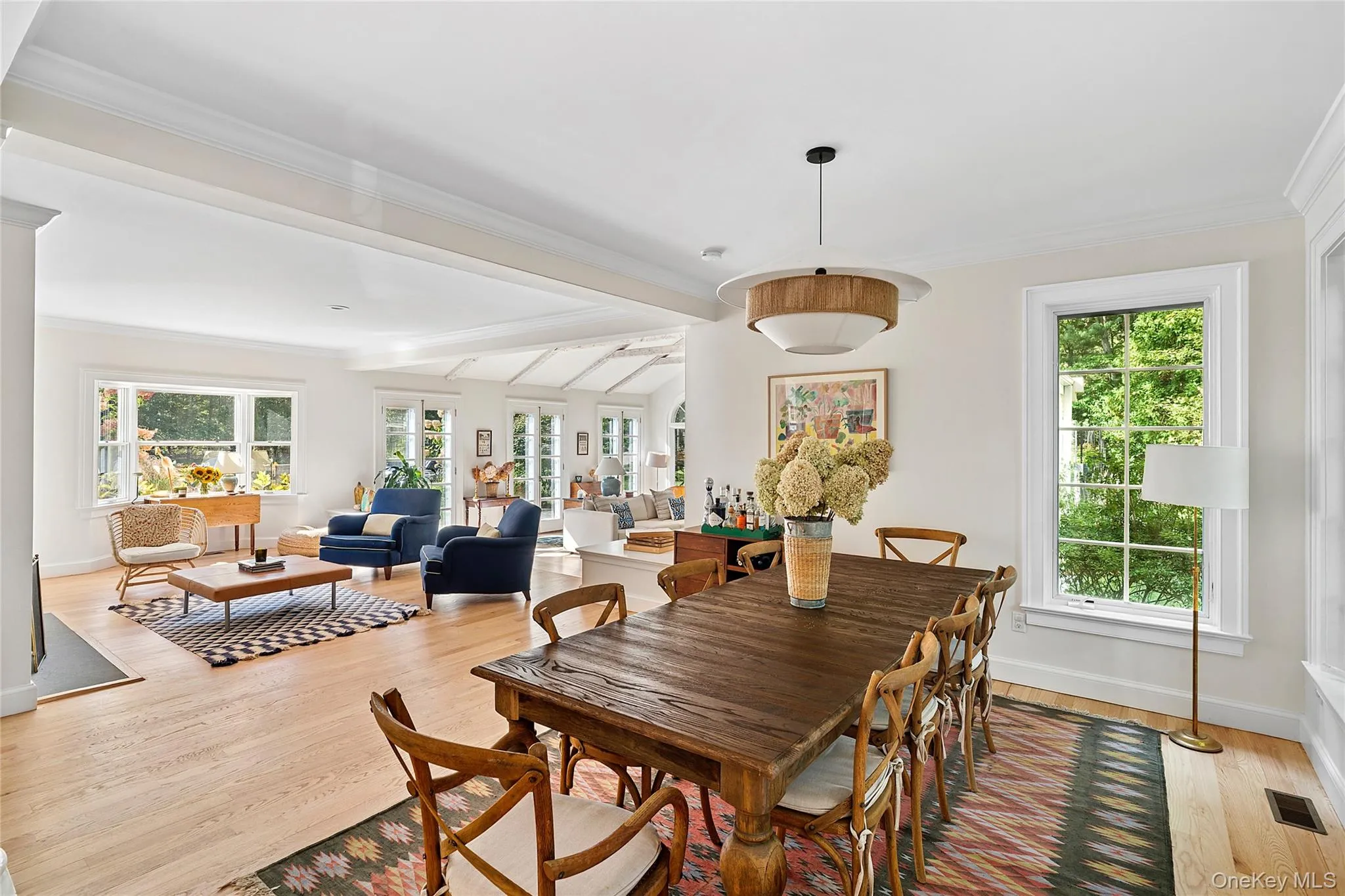 Dining room with light wood-style floors and ornamental molding Dining room with light wood-style floors and ornamental molding