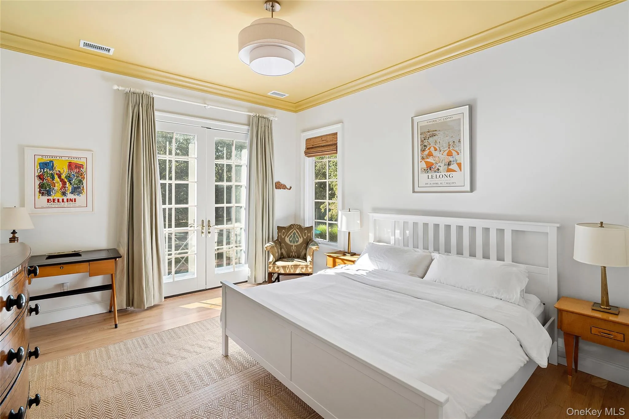 Bedroom with crown molding, light wood-type flooring, french doors, and access to exterior Bedroom with crown molding, light wood-type flooring, french doors, and access to exterior