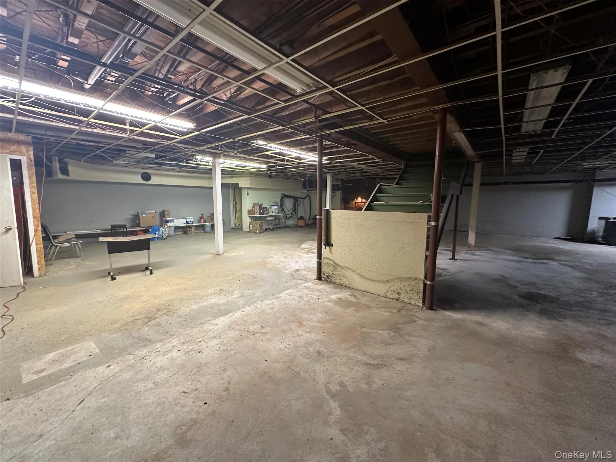 Unfinished basement featuring stairs Unfinished basement featuring stairs