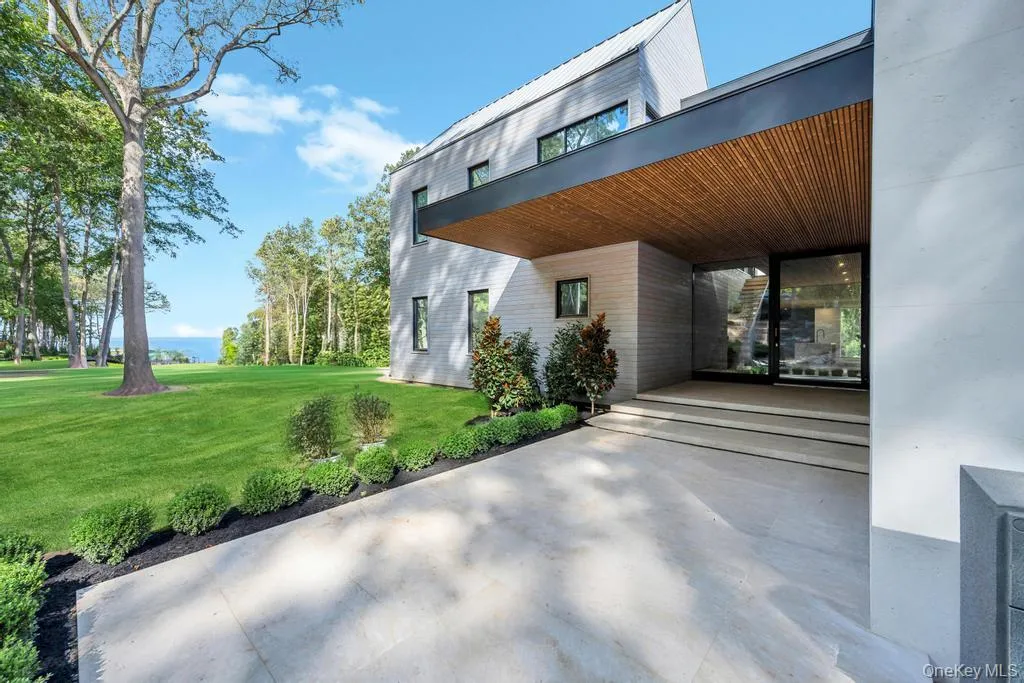 Property entrance with a lawn and a patio area Property entrance with a lawn and a patio area