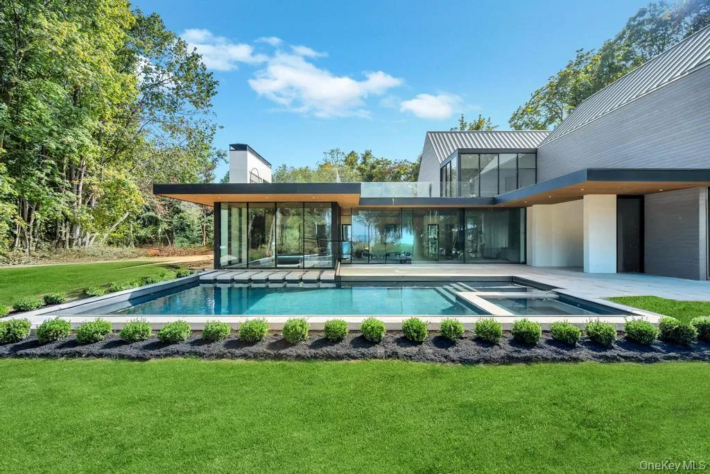 View of swimming pool featuring a lawn, a patio area, and a pool with connected hot tub View of swimming pool featuring a lawn, a patio area, and a pool with connected hot tub